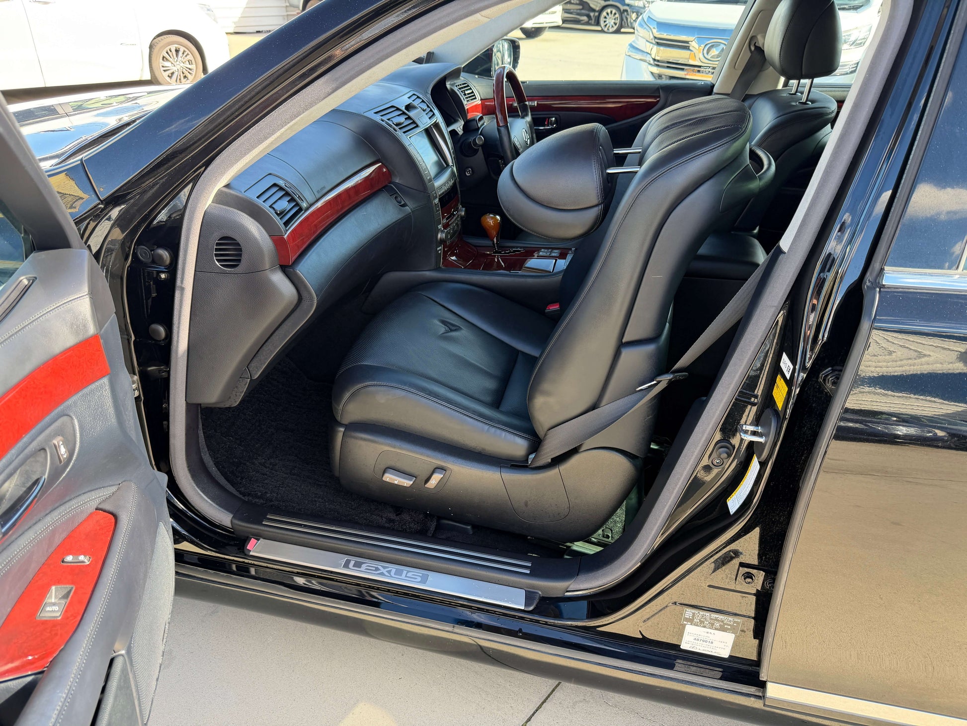 Interior view of a 2007 Lexus LS600hL AWD V8 5.0L Hybrid luxury sedan showcasing rear seats and dashboard details.