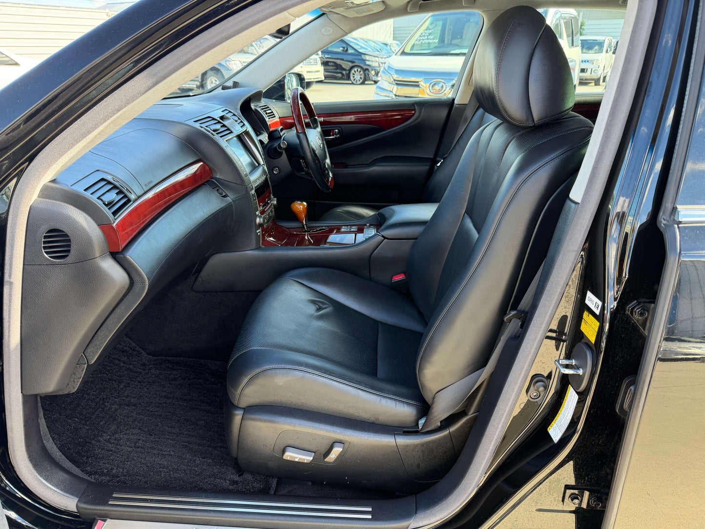 Interior view of a 2007 Lexus LS600hL AWD V8 5.0L Hybrid luxury sedan showing black leather seating.