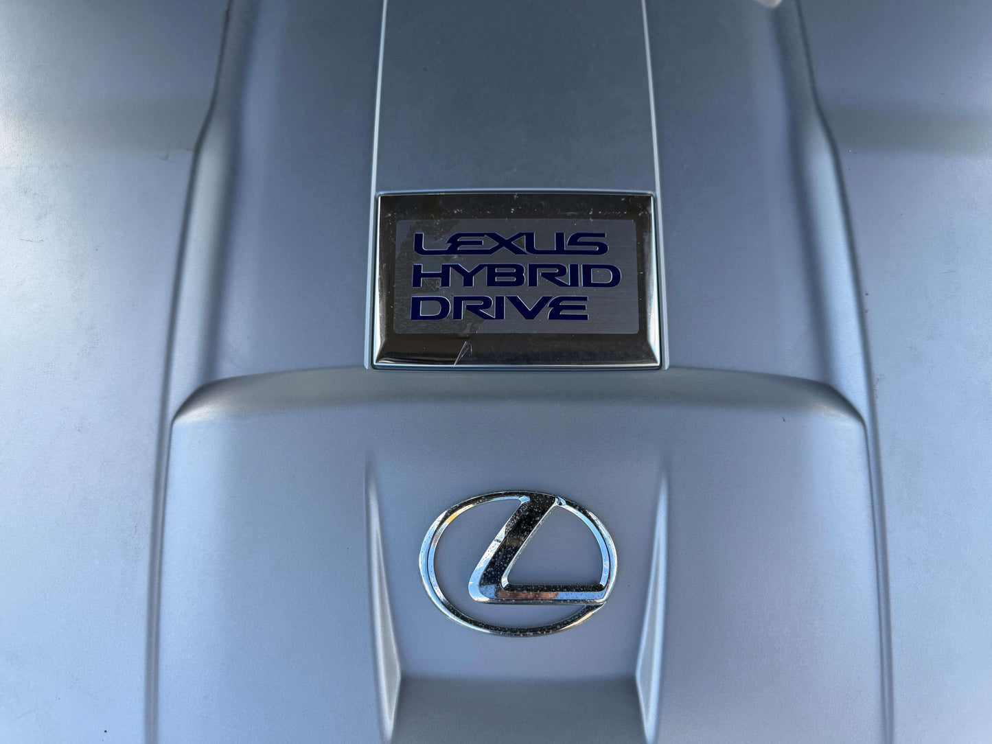 Lexus Hybrid Drive system close-up on the engine cover of a 2007 Lexus LS600hL AWD V8 5.0L Hybrid luxury sedan.