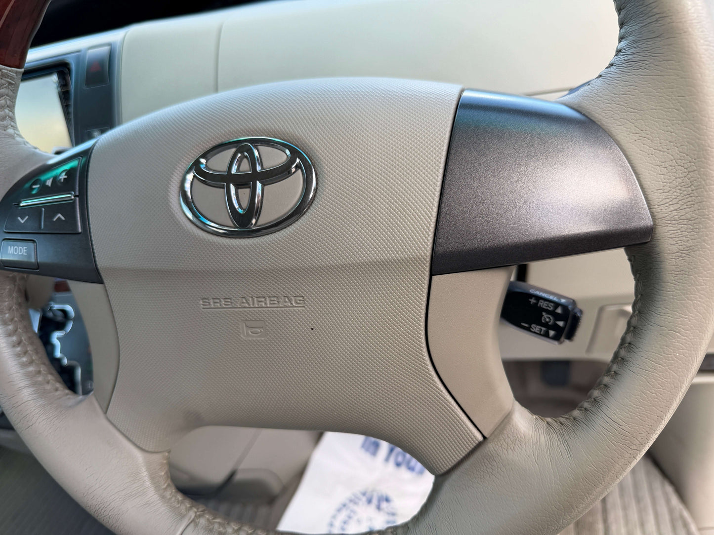 2010 Toyota Estima 2.4L 4WD steering wheel with airbag and controls for audio and cruise settings.