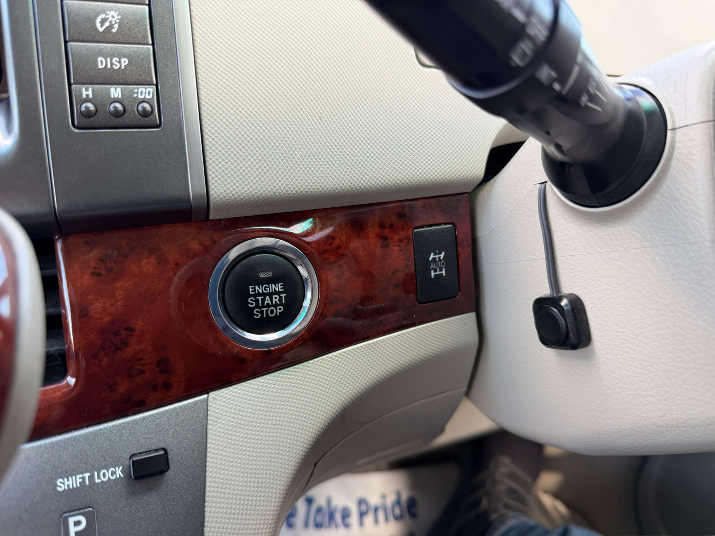 2010 Toyota Estima 2.4L 4WD interior showing engine start stop button and gear shift, featuring premium detailing.