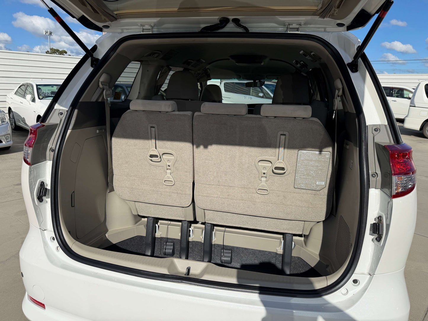 Interior cargo space of 2010 Toyota Estima 2.4L 4WD showing folded rear seats.