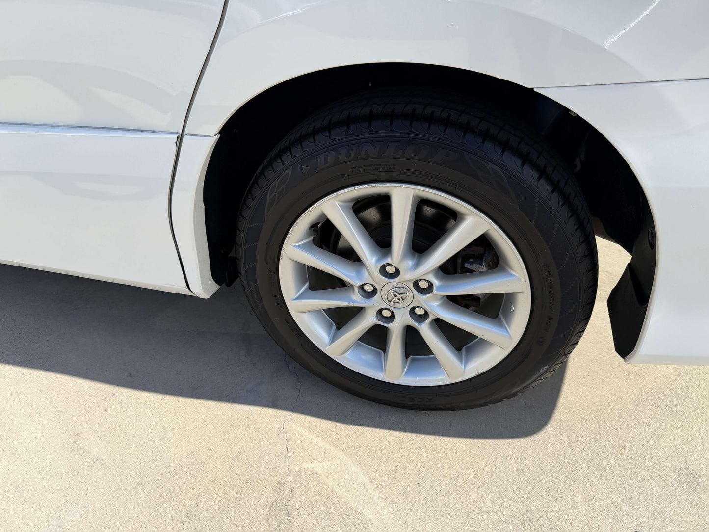 Close-up of the wheel of a 2010 Toyota Estima 2.4L 4WD showcasing alloy rims and tire.
