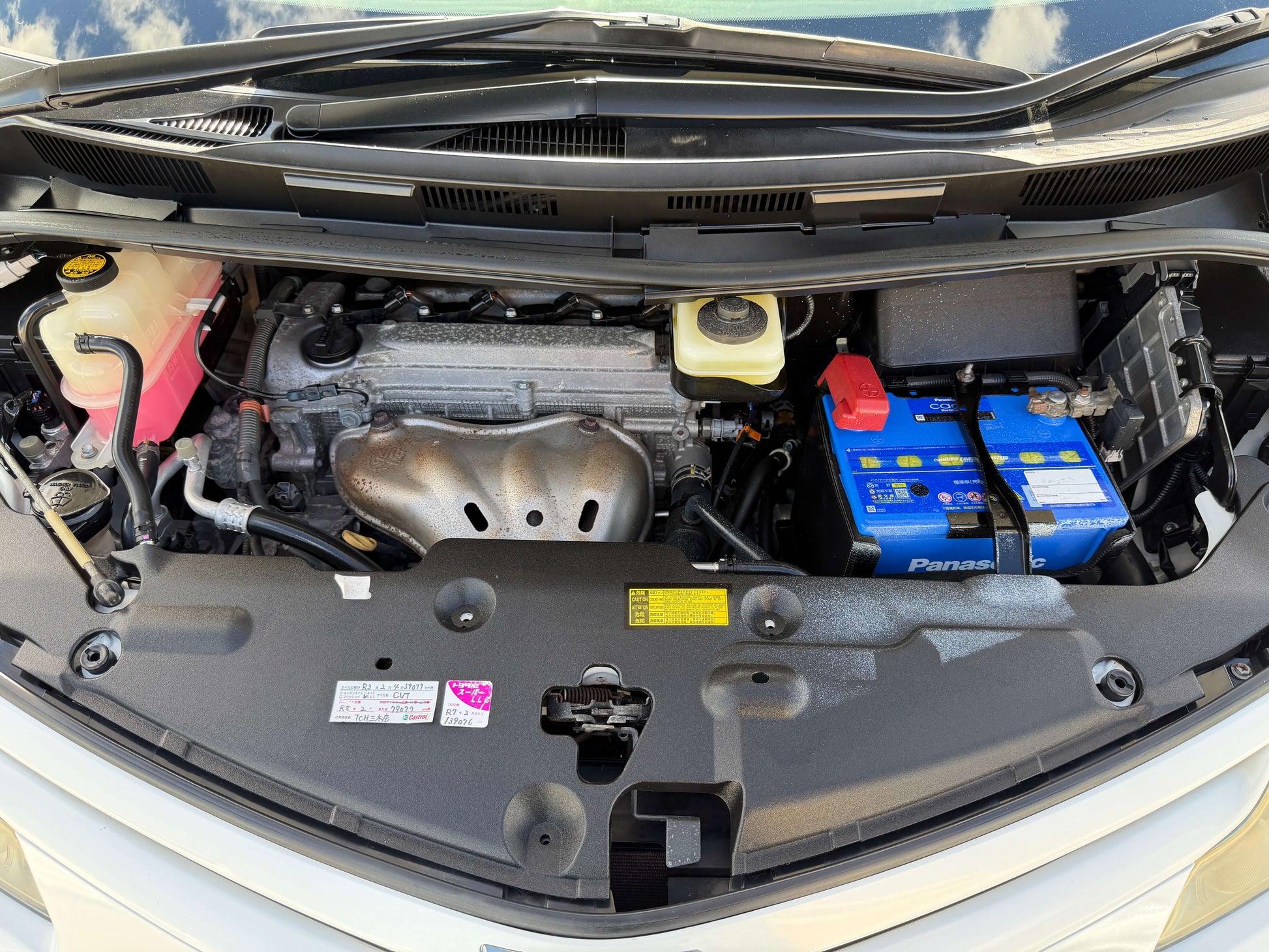 2010 Toyota Estima 2.4L 4WD engine compartment view with battery and components.