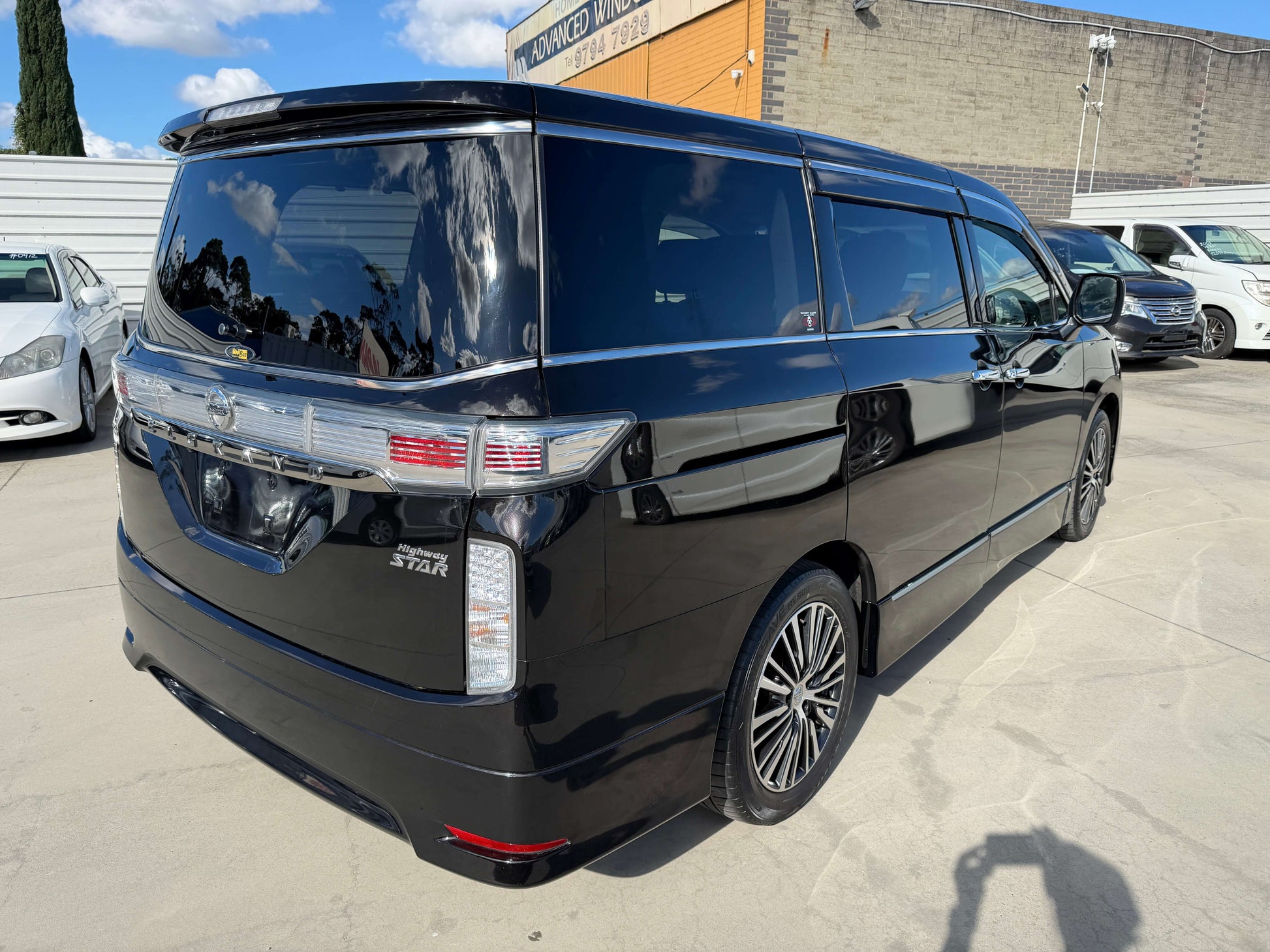 2015 Nissan Elgrand 2.5L 250 Highway Star rear view showcasing sleek design and luxury features.