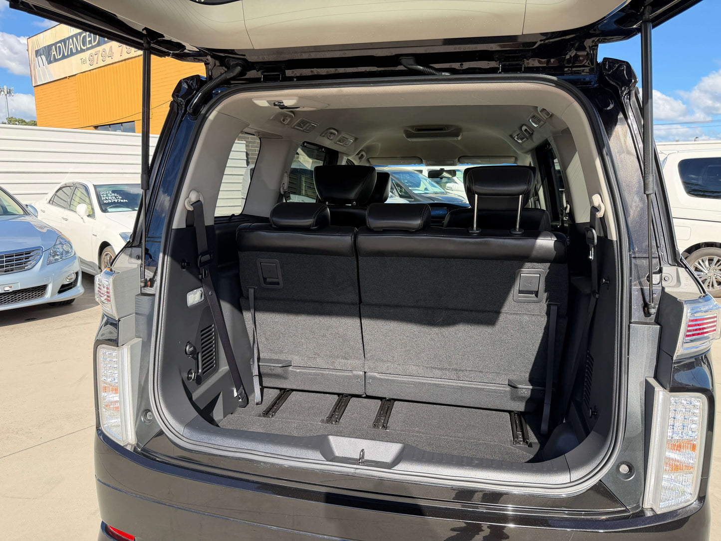 2015 Nissan Elgrand 2.5L rear cargo space with foldable seats in premium people mover.