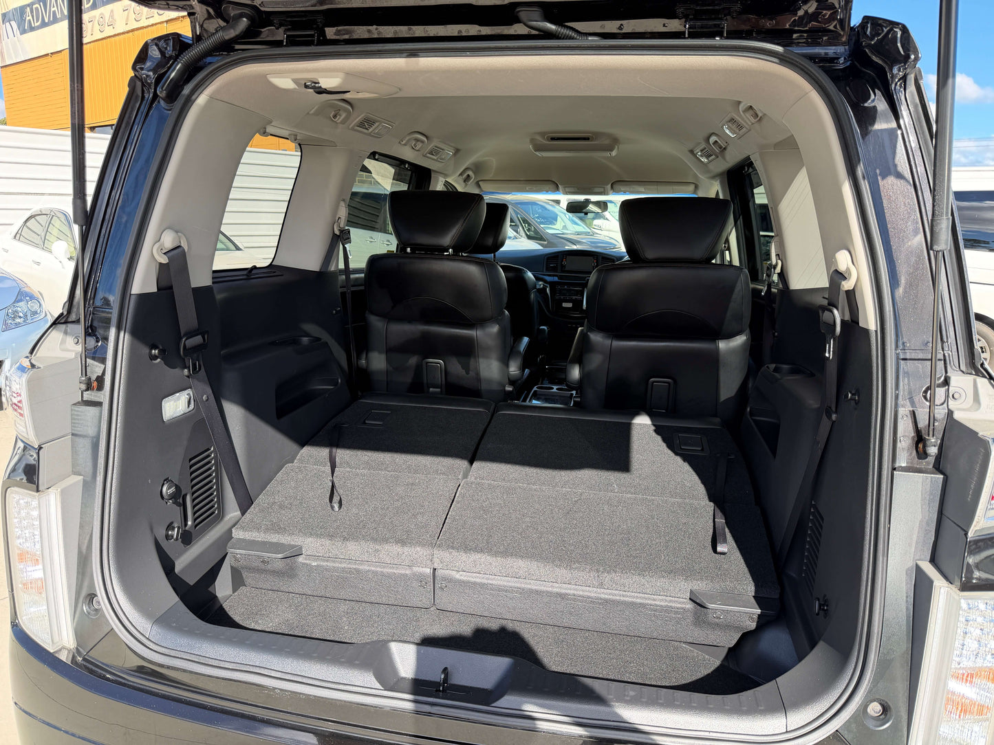 Interior view of the 2015 Nissan Elgrand 2.5L showing spacious rear cargo area with seats folded down.