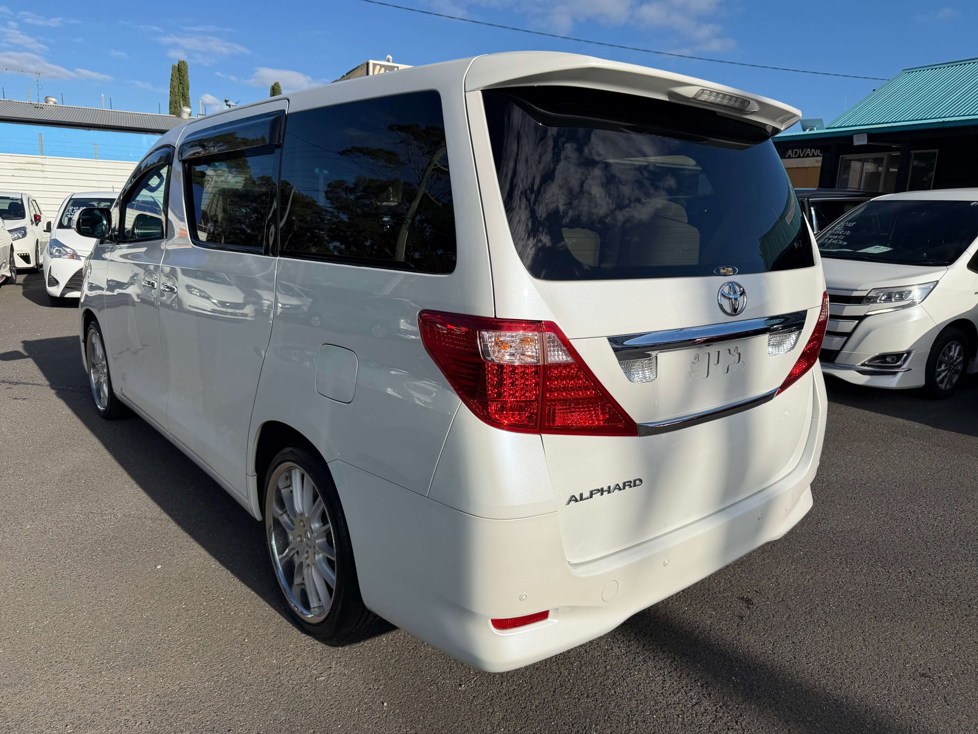 2009 Toyota Alphard 2.4L G Edition rear view, showcasing its sleek design and spacious interior.