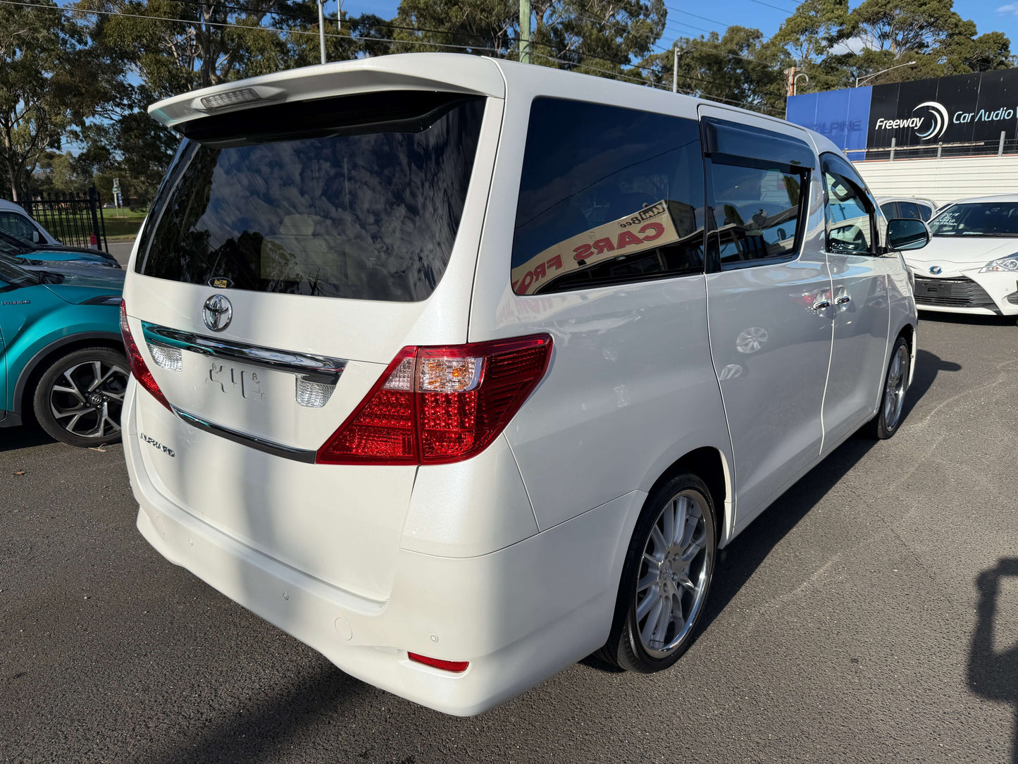 2009 Toyota Alphard 2.4L G Edition rear view, white 8-seater people mover with stylish design.