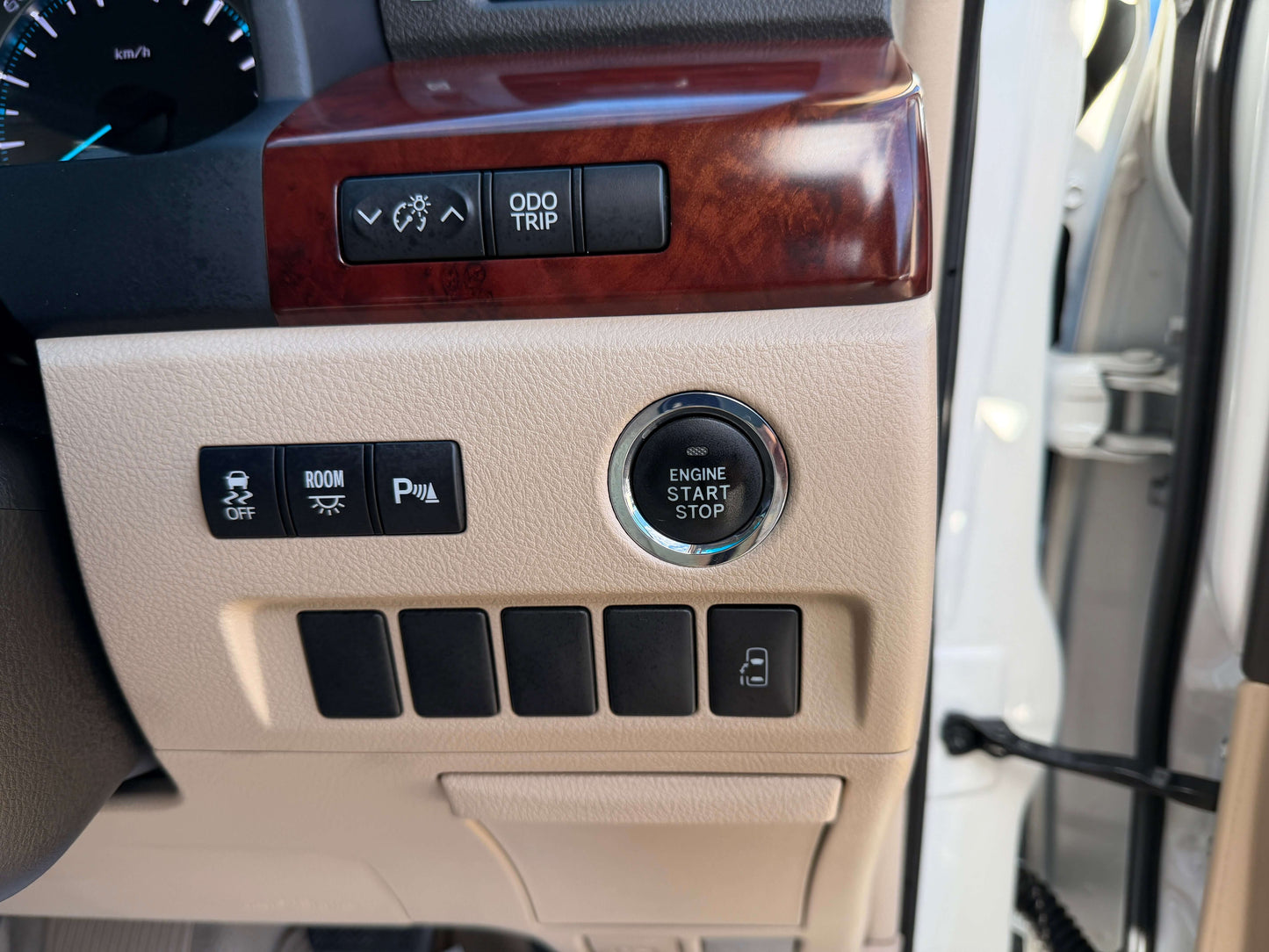 Interior view of 2009 Toyota Alphard 2.4L with engine start stop button and control panel.