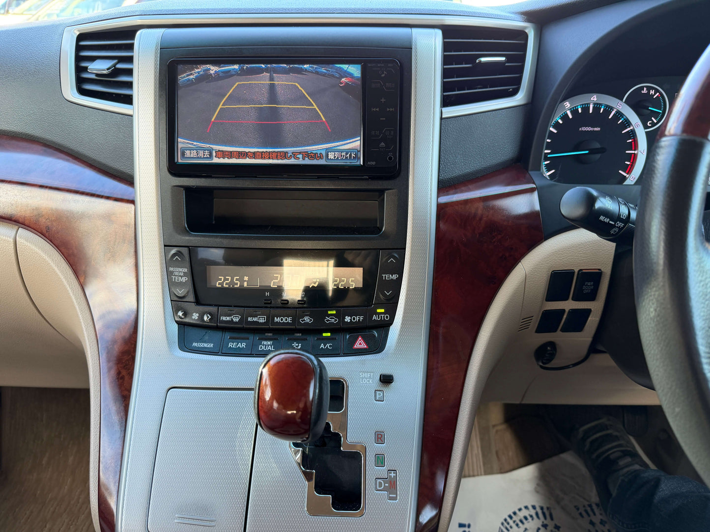 Interior view of a 2009 Toyota Alphard 2.4L G Edition dashboard with control panel and rearview camera display.