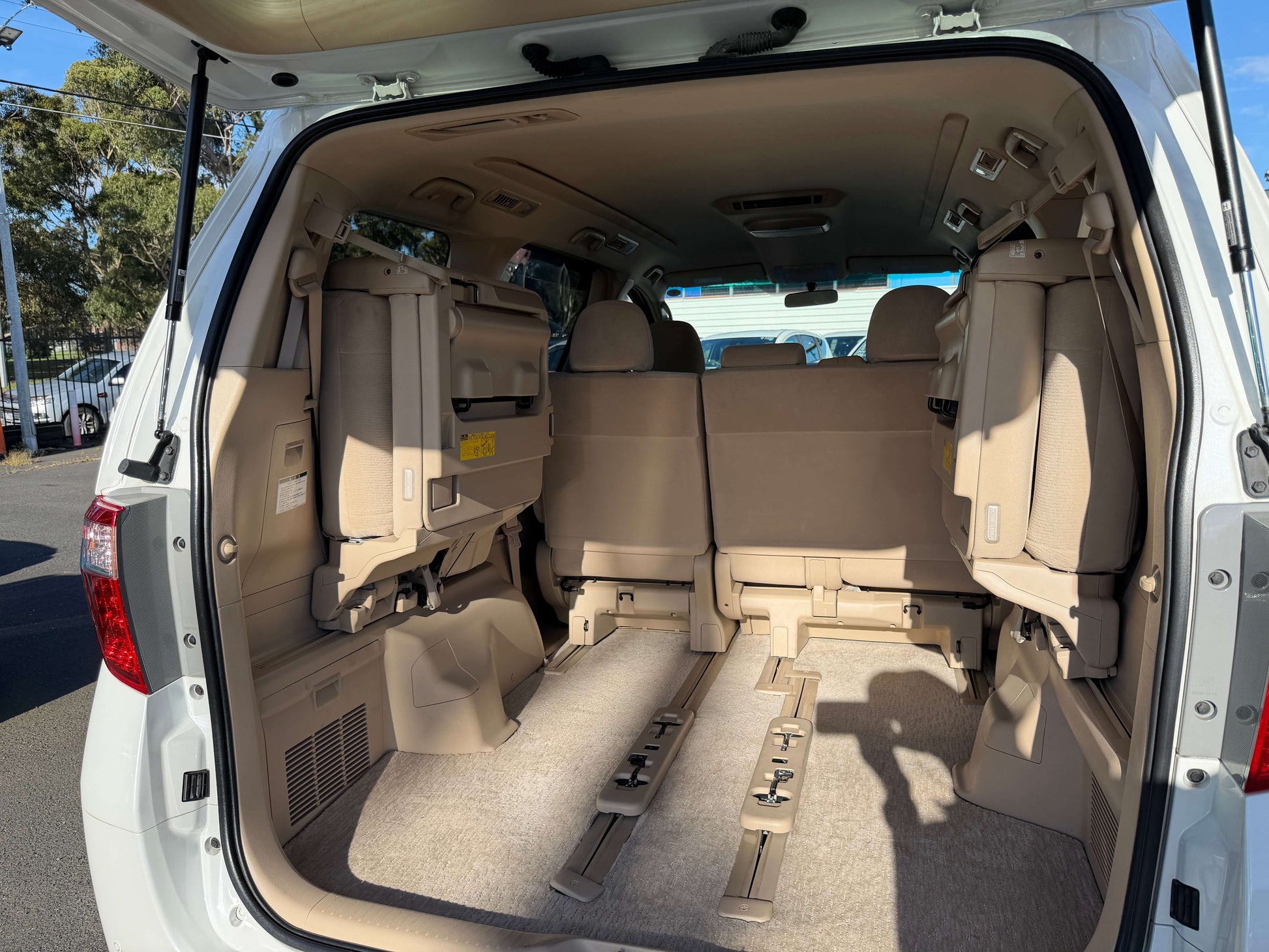 Interior view of the 2009 Toyota Alphard 2.4L showing spacious seating configuration in beige upholstery.