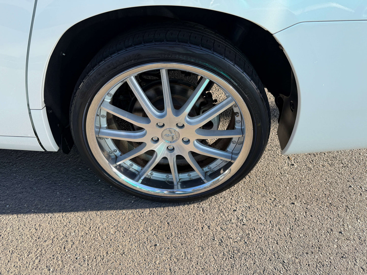 Close-up of a chrome alloy wheel on a 2009 Toyota Alphard 2.4L, showcasing 8-seat luxury and performance.