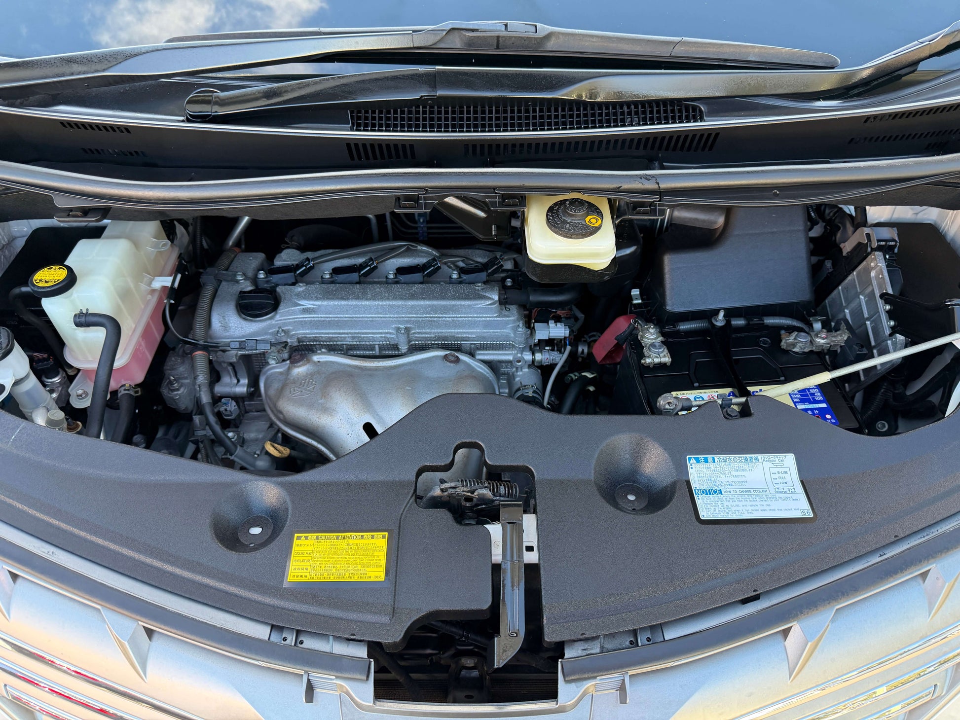 2009 Toyota Alphard 2.4L engine compartment view showcasing the 2.4L engine in detail.
