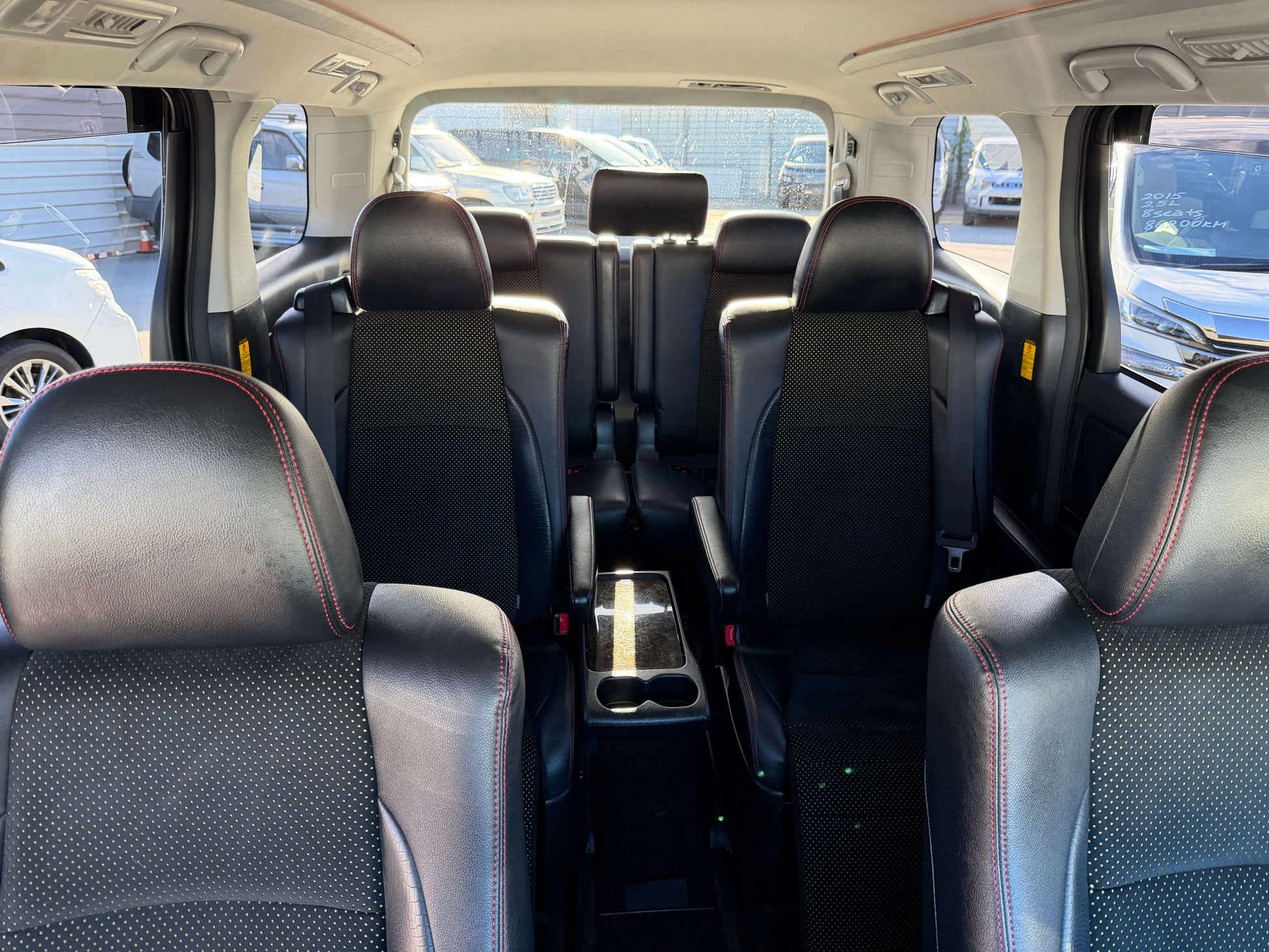 2014 Toyota Vellfire 2.4L interior with 7 seats showcasing black leather upholstery and spacious seating arrangement.