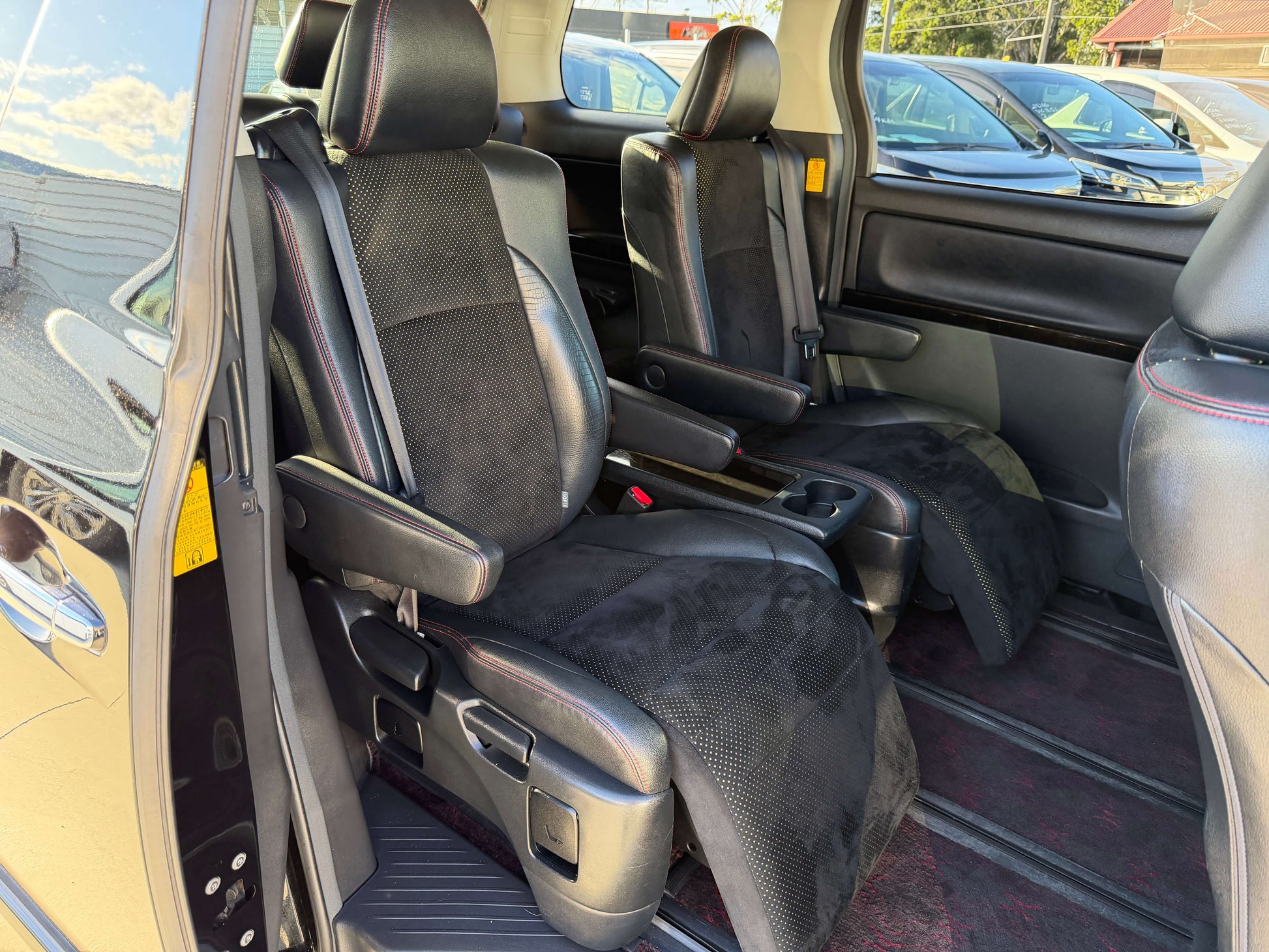 Interior view of 2014 Toyota Vellfire 2.4L Z Golden Eyes II Edition featuring black cloth seats.