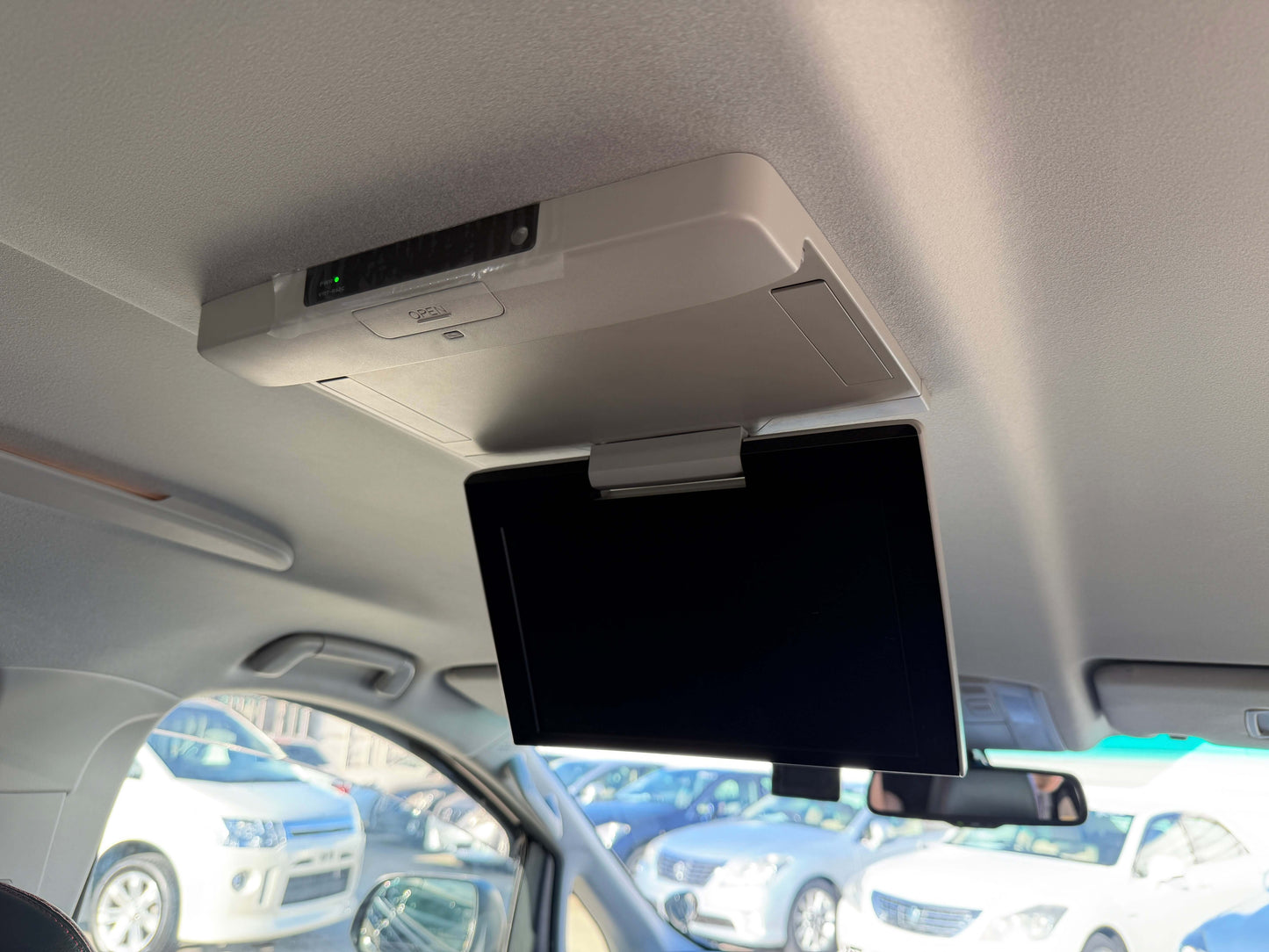 Interior view of a 2014 Toyota Vellfire 2.4L displaying a ceiling-mounted monitor.