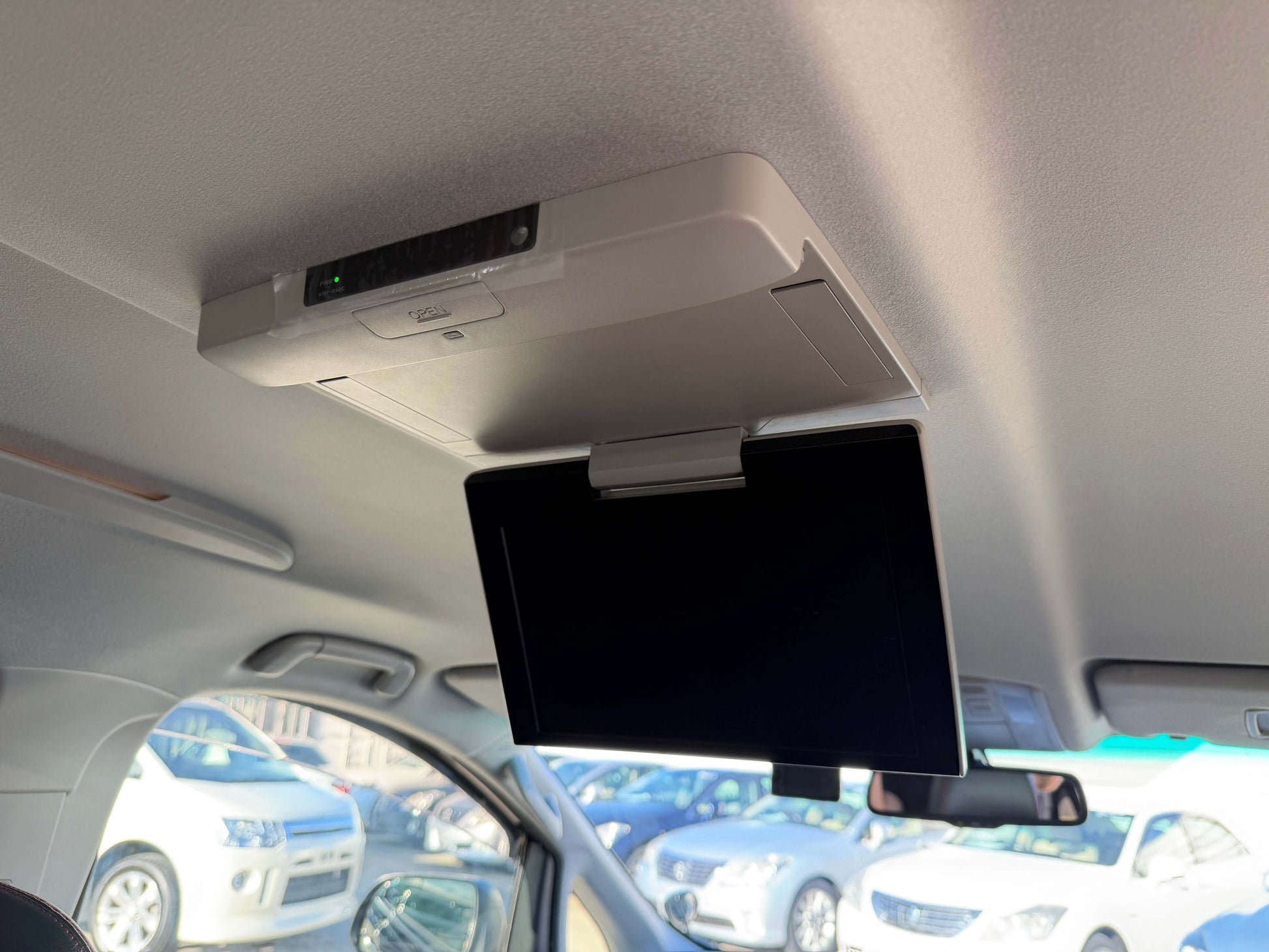 Interior view of a 2014 Toyota Vellfire 2.4L displaying a ceiling-mounted monitor.