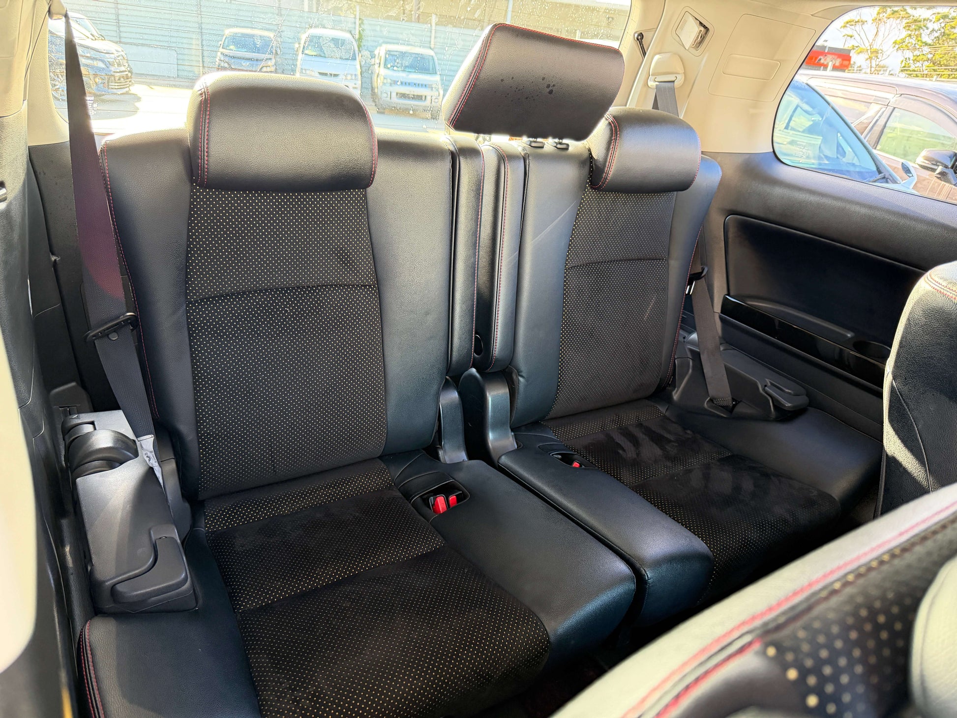 Interior view of the rear seats in a 2014 Toyota Vellfire 2.4L Z Golden Eyes II Edition, featuring 7 seats.