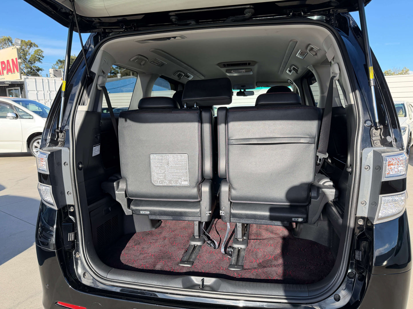 Interior view of the rear seating area in a 2014 Toyota Vellfire 2.4L Z Golden Eyes II Edition with 7 seats.