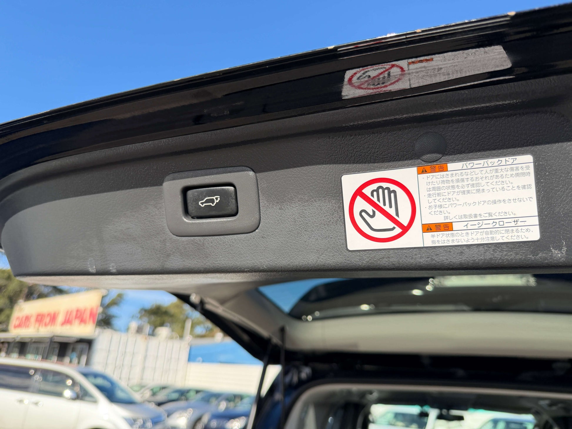 Button and warning labels inside the 2014 Toyota Vellfire 2.4L Z Golden Eyes II Edition vehicle.