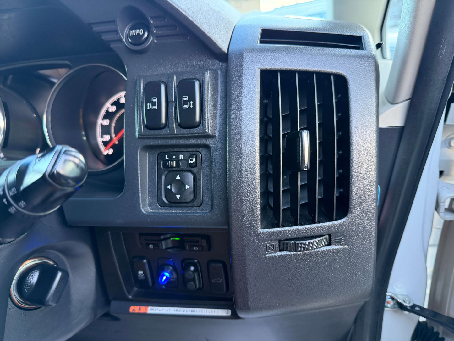 Interior control panel of a 2017 Mitsubishi Delica D5 2.3 Diesel-Turbo 4WD showing switches and air vents.