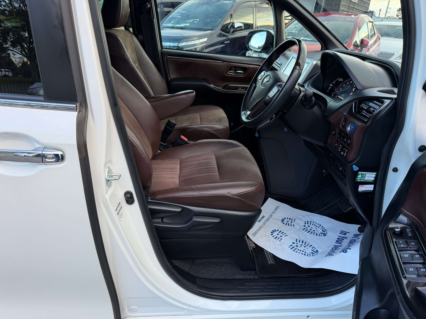 Interior view of a 2018 Toyota Esquire 1.8L Hybrid Gi Premium with leather seats and dashboard.
