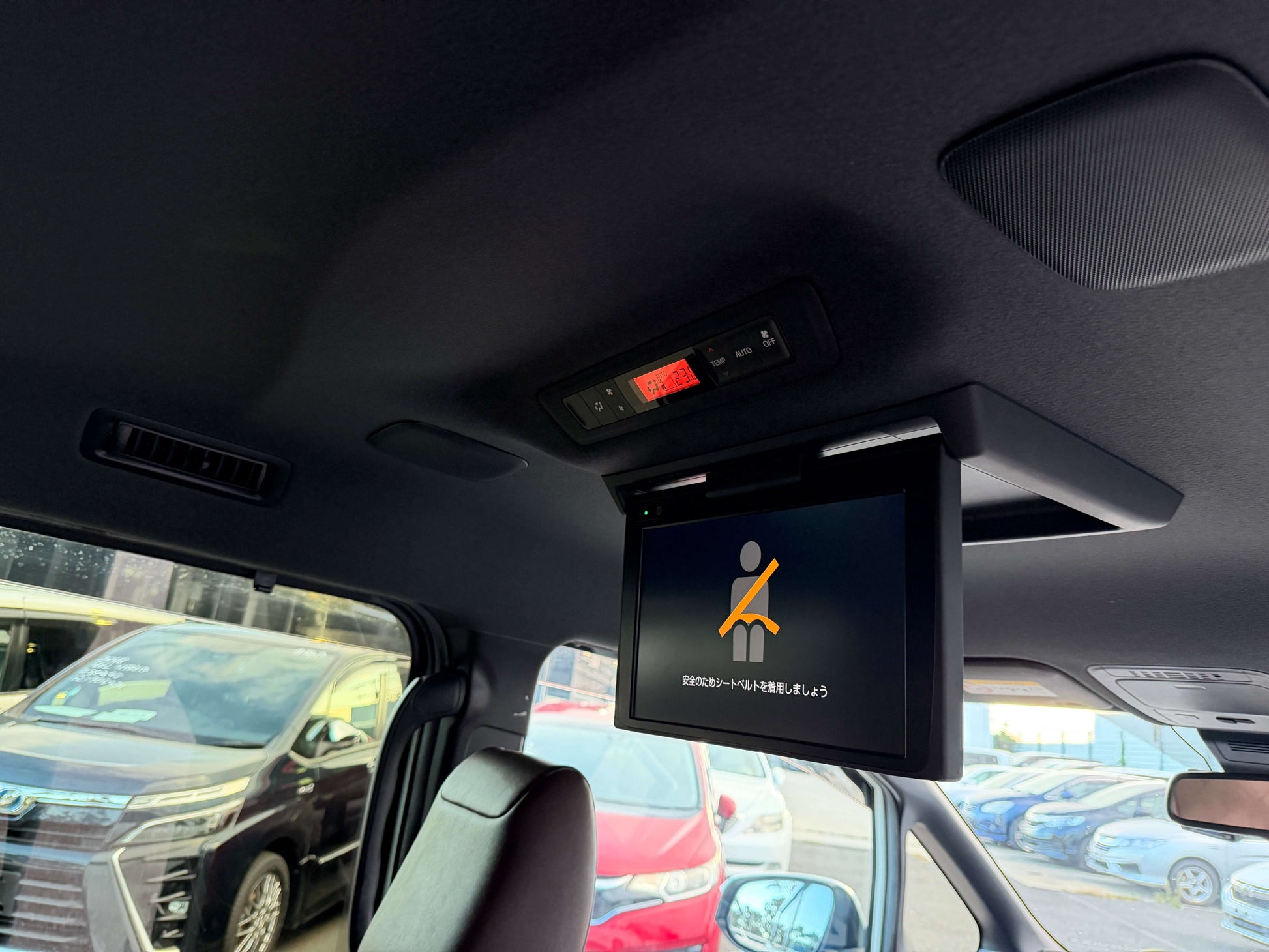 Interior view of a 2018 Toyota Esquire 1.8L Hybrid with overhead entertainment monitor and speakers