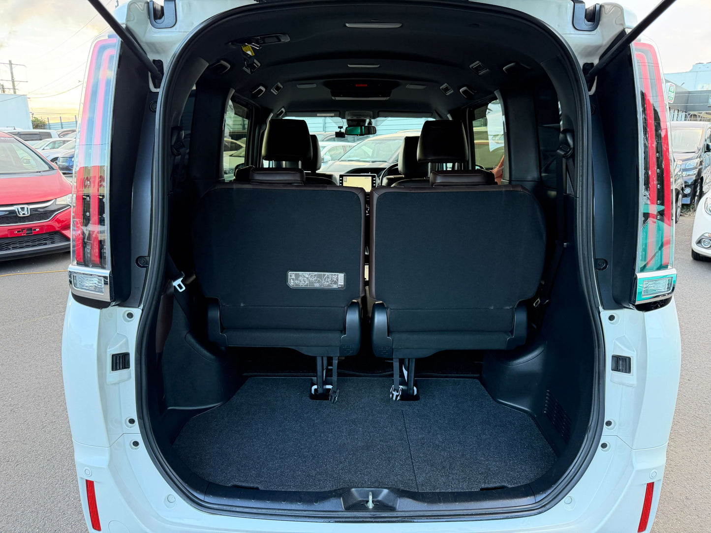 Interior view of the rear seating area of 2018 Toyota Esquire 1.8L Hybrid, showcasing spacious 7 seat configuration.