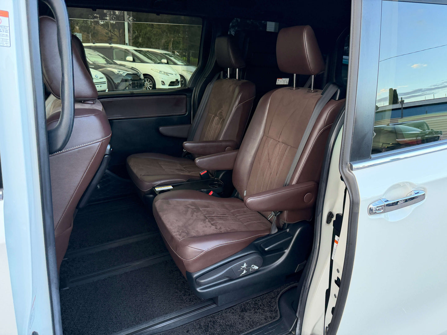 Interior view of 2018 Toyota Esquire 1.8L Hybrid Gi Premium showing brown leather seats, highlighting spacious 7-seater configuration.