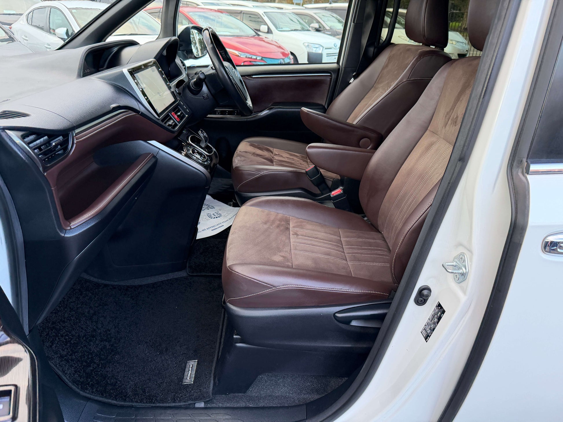 Interior view of 2018 Toyota Esquire 1.8L Hybrid, showcasing premium brown leather seats and modern dashboard design.