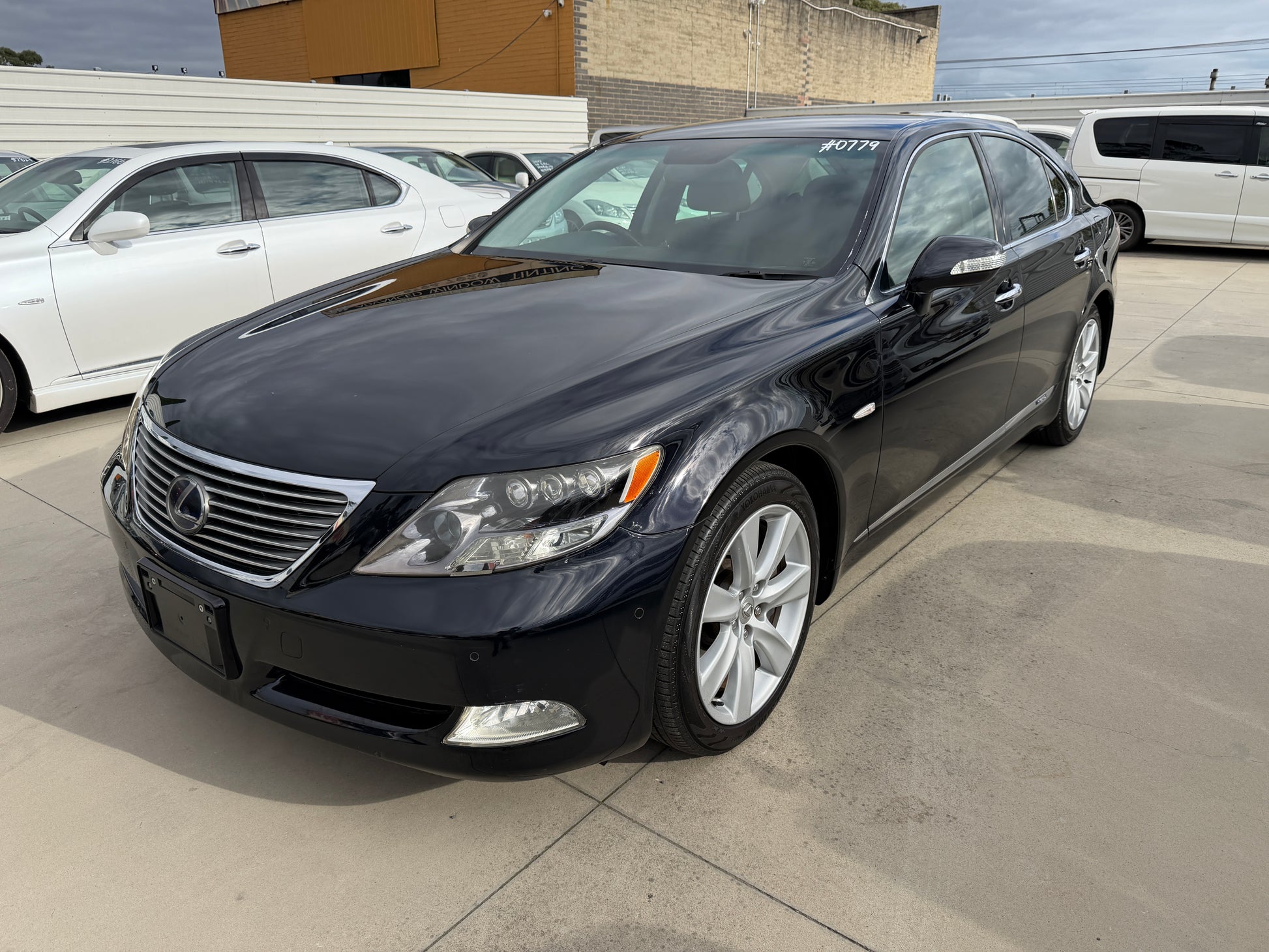 2007 Lexus LS600h AWD V8 5.0L Hybrid black luxury sedan front three-quarter view with #0779 stock label