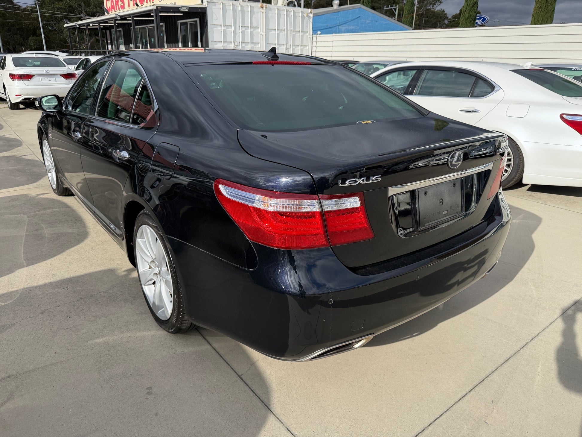 2007 Lexus LS600h AWD V8 5.0L Hybrid black luxury sedan rear three-quarter view showing Lexus badge and tail lights