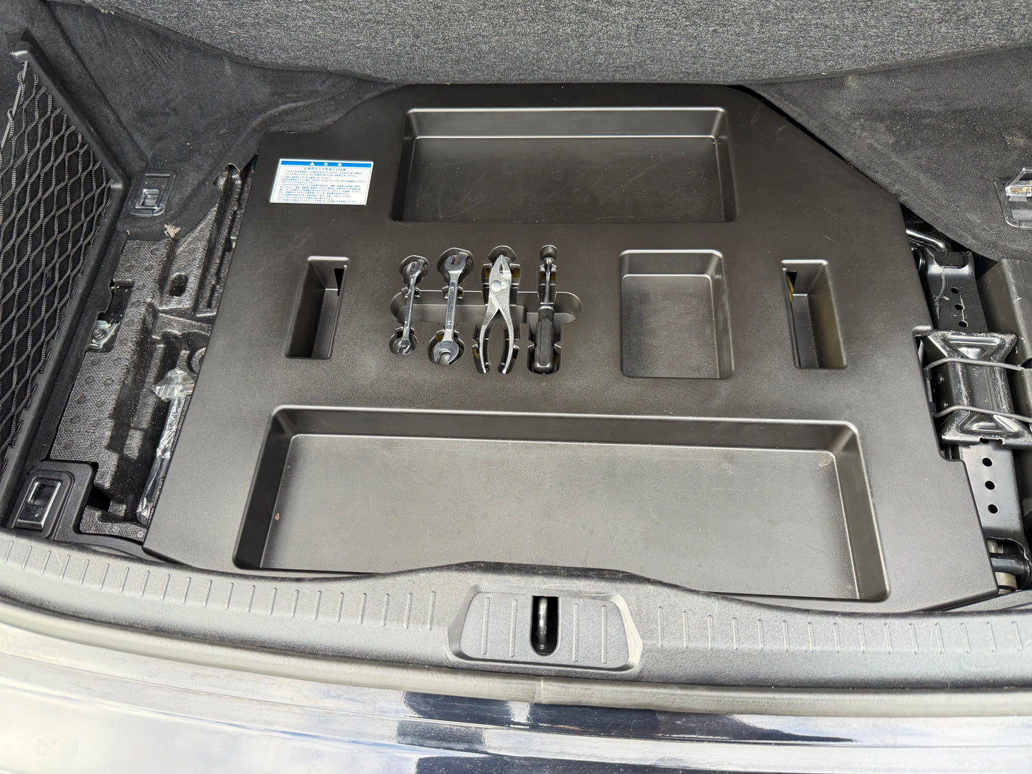 2007 Lexus LS600h AWD V8 5.0L Hybrid spare tyre compartment showing Bridgestone temporary spare wheel