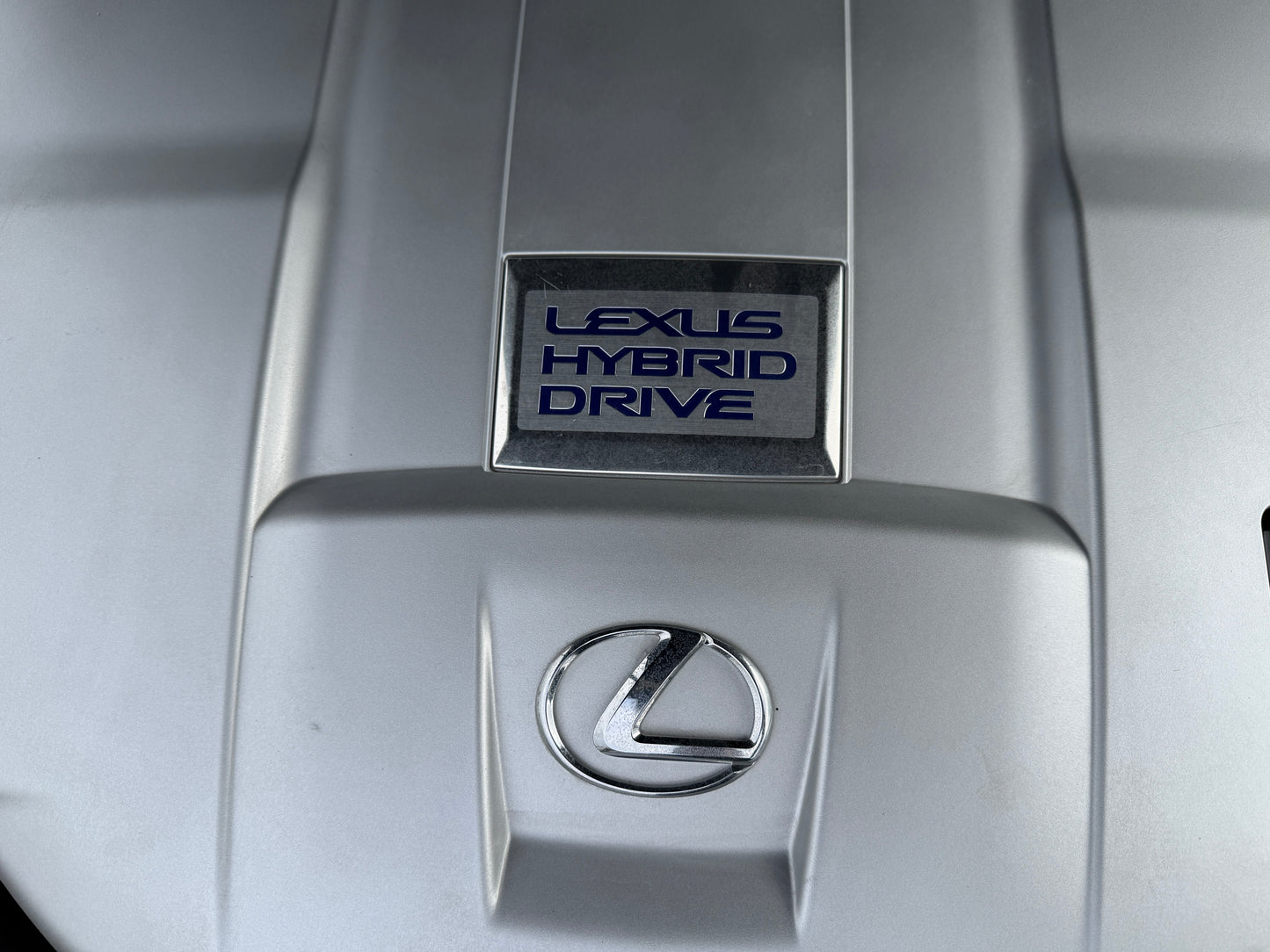 2007 Lexus LS600h AWD V8 5.0L Hybrid close-up of Lexus Hybrid Drive badge on engine cover