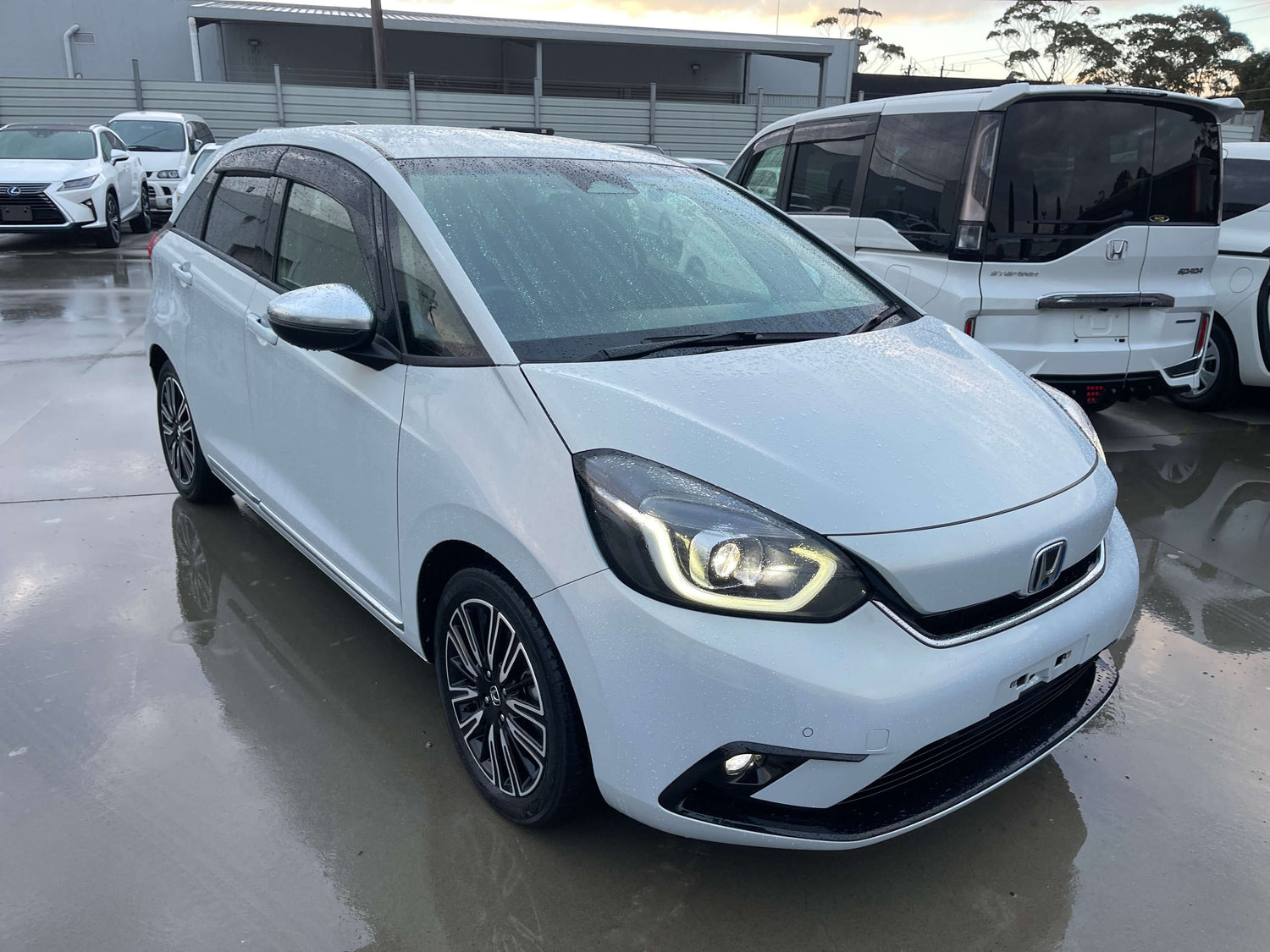 2020 Honda Fit 1.5 e:HEV Home Edition in white color parked, showcasing its modern design and hybrid features.