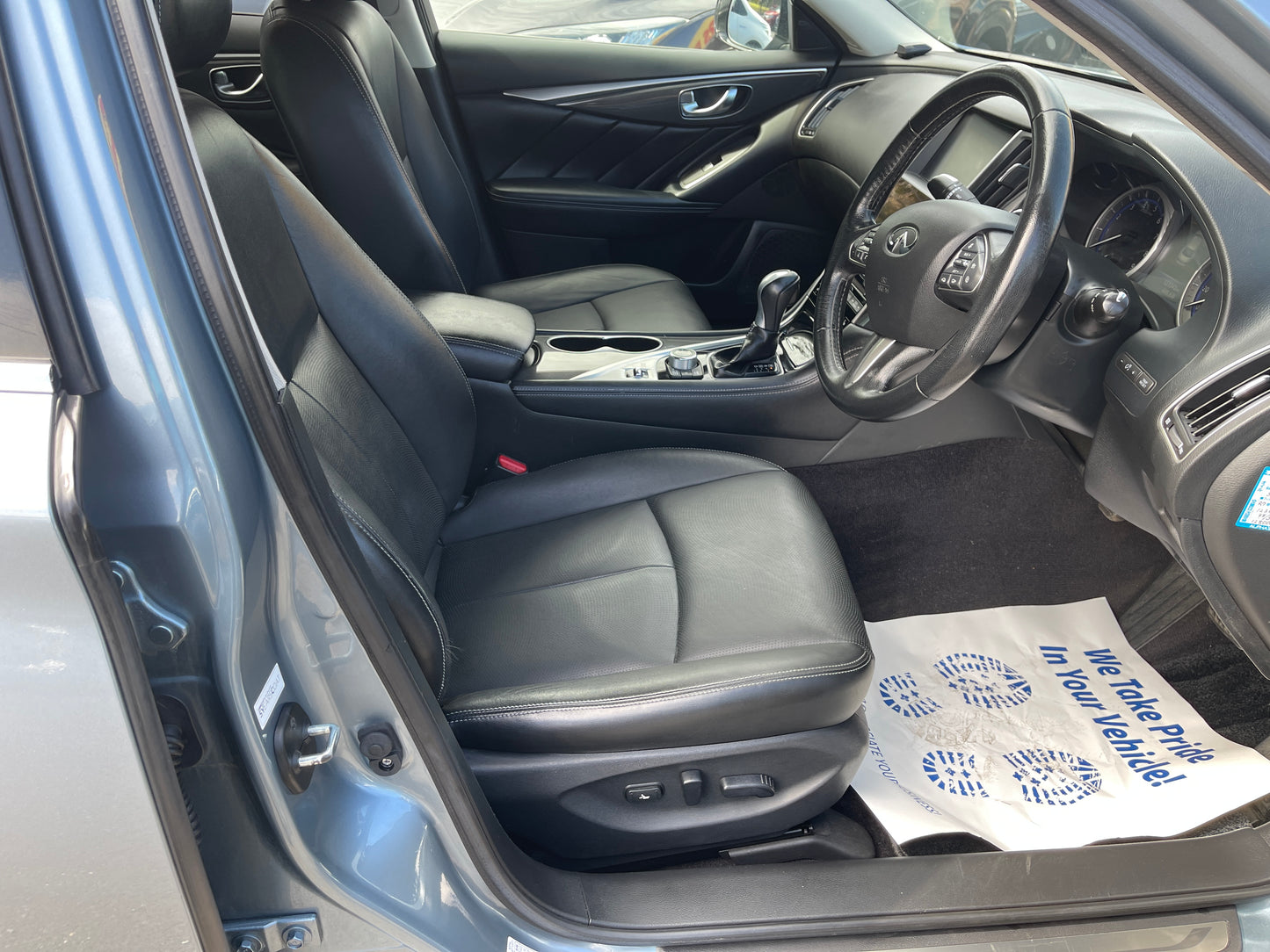 Interior view of a 2016 Nissan Skyline V6 3.5L Hybrid 350GT, featuring leather seats and a modern dashboard.