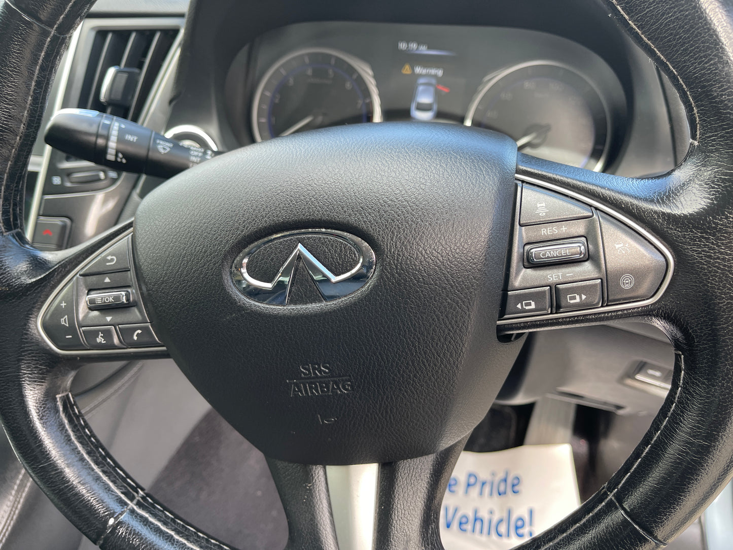 2016 Nissan Skyline V6 3.5L Hybrid steering wheel with controls and dashboard in background.