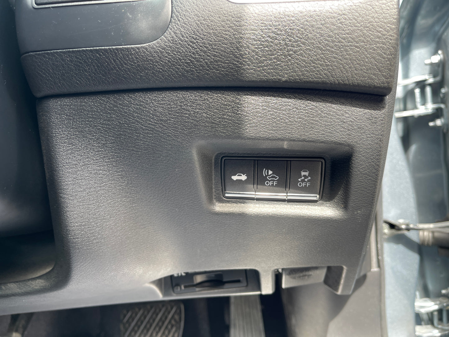 Interior controls of a 2016 Nissan Skyline V6 3.5L Hybrid, featuring buttons for trunk release and vehicle settings.