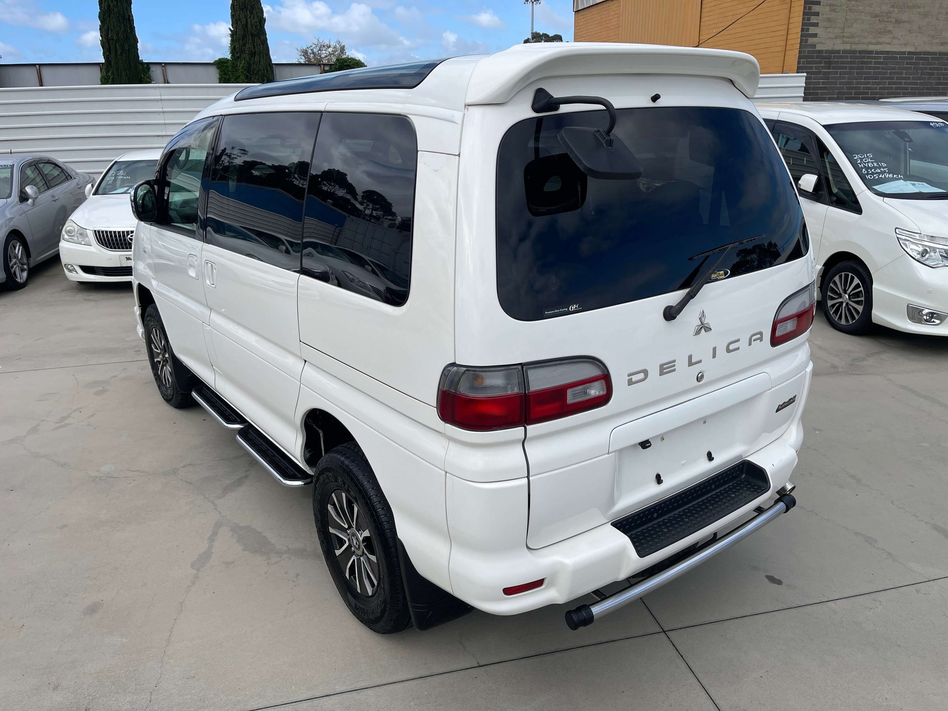 2006 Mitsubishi Delica V6 3.0L 4WD Active Field edition white van rear view in a parking lot