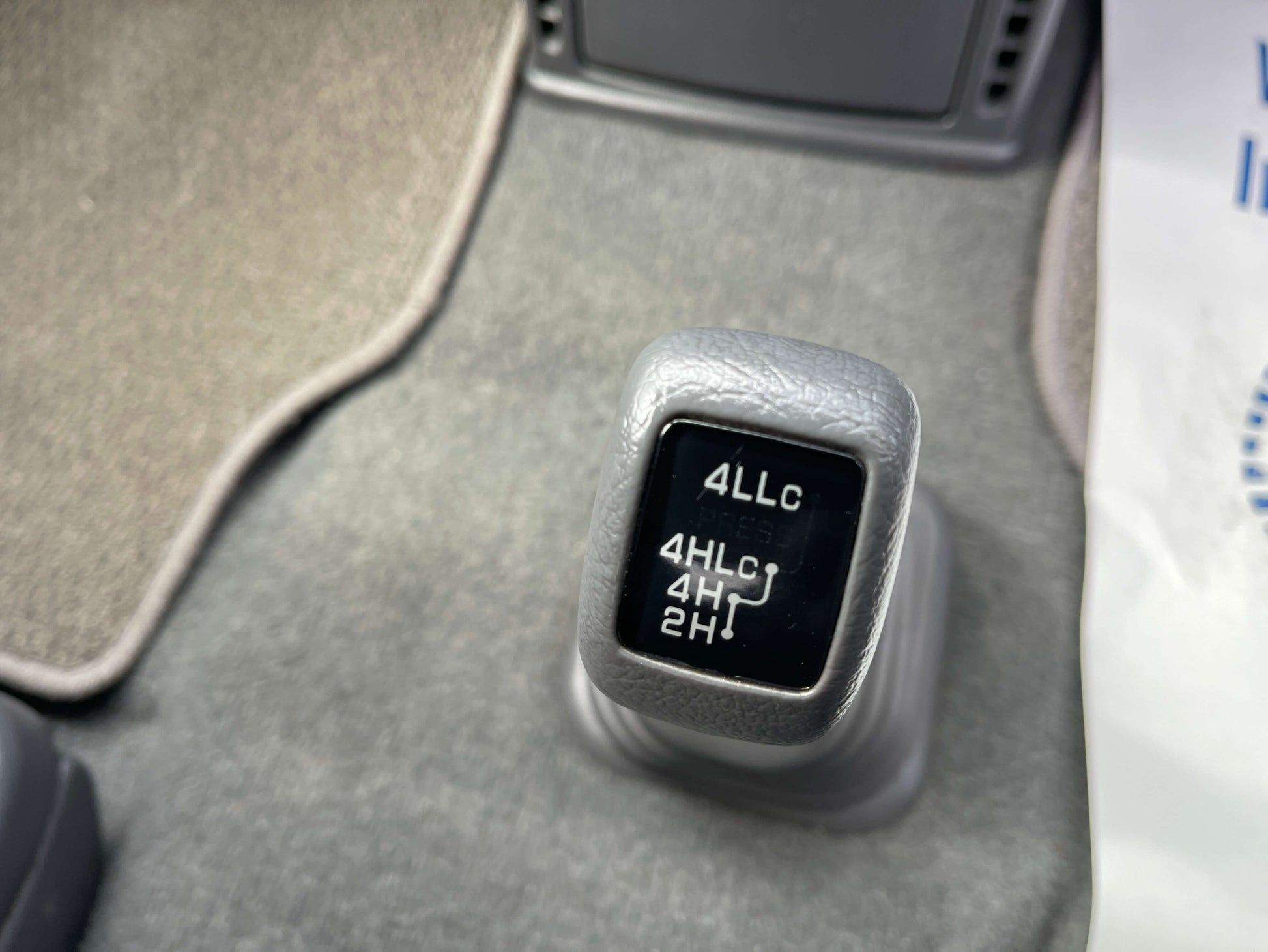 Gear shift knob showing 4WD settings for 2006 Mitsubishi Delica V6 3.0L Active Field Edition.