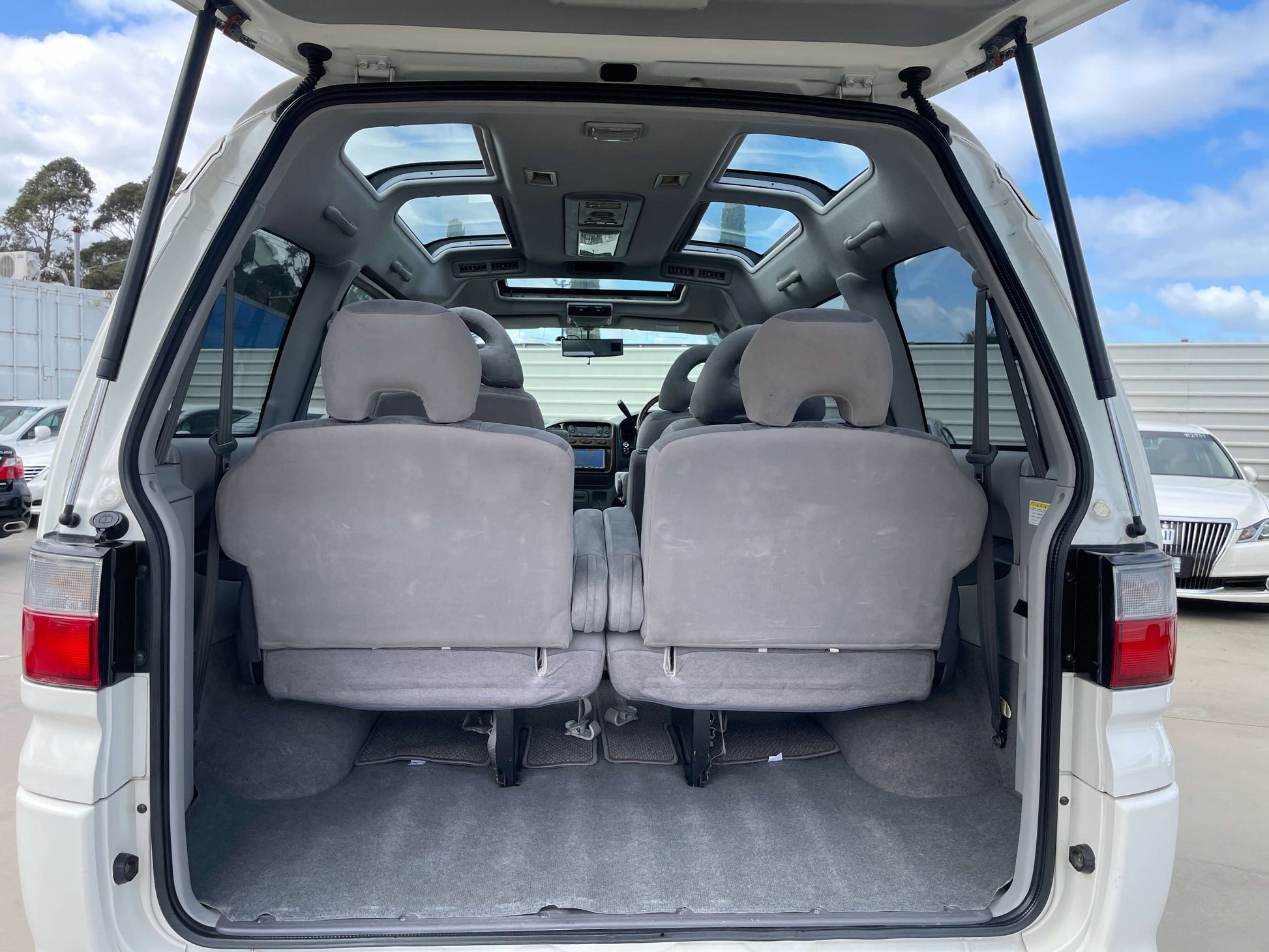 Interior view of the 2006 Mitsubishi Delica space gear showing back seats and skylite roof.