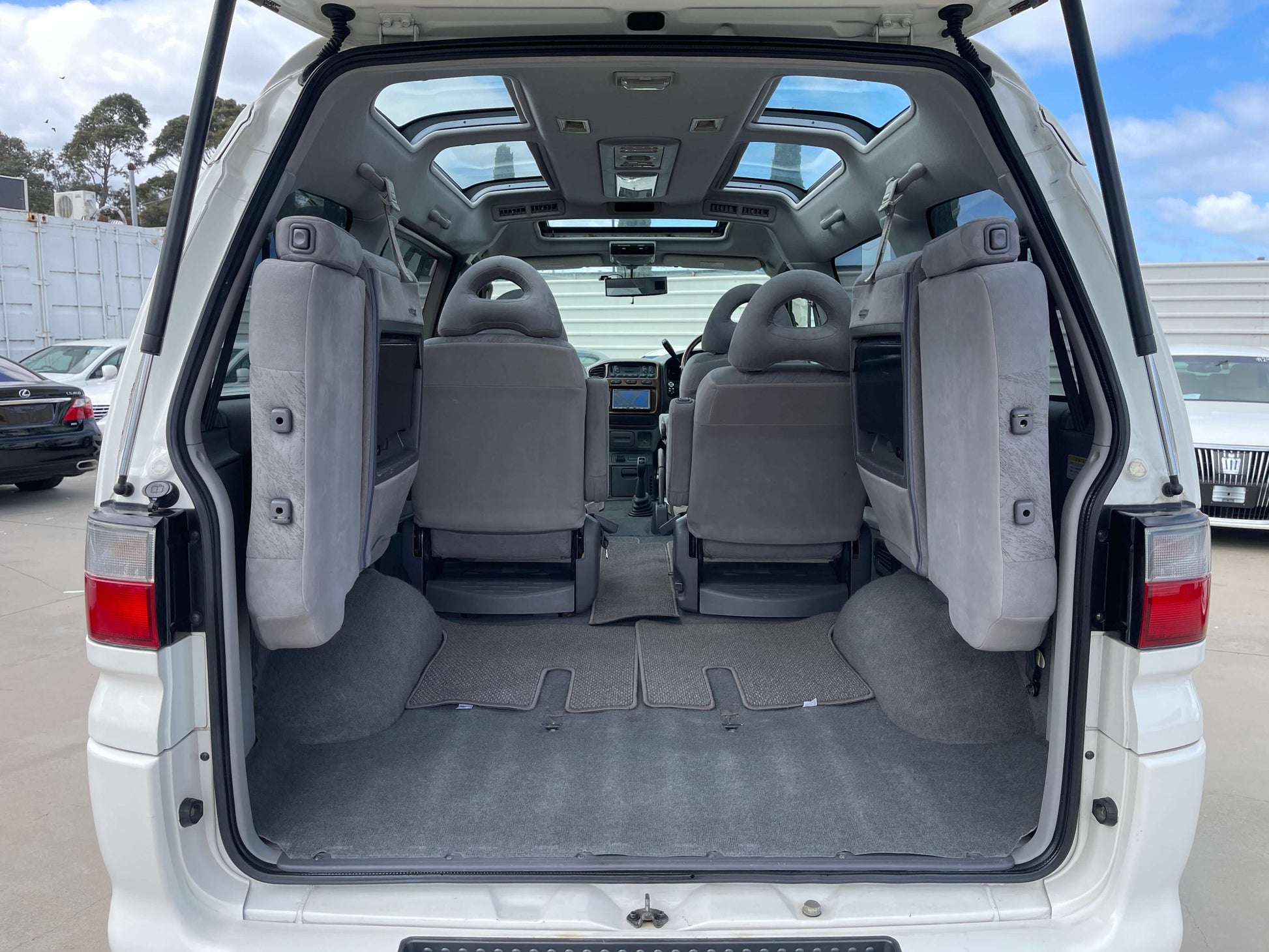 Interior view of a 2006 Mitsubishi Delica showcasing spacious seating with skylite roof and cargo area.