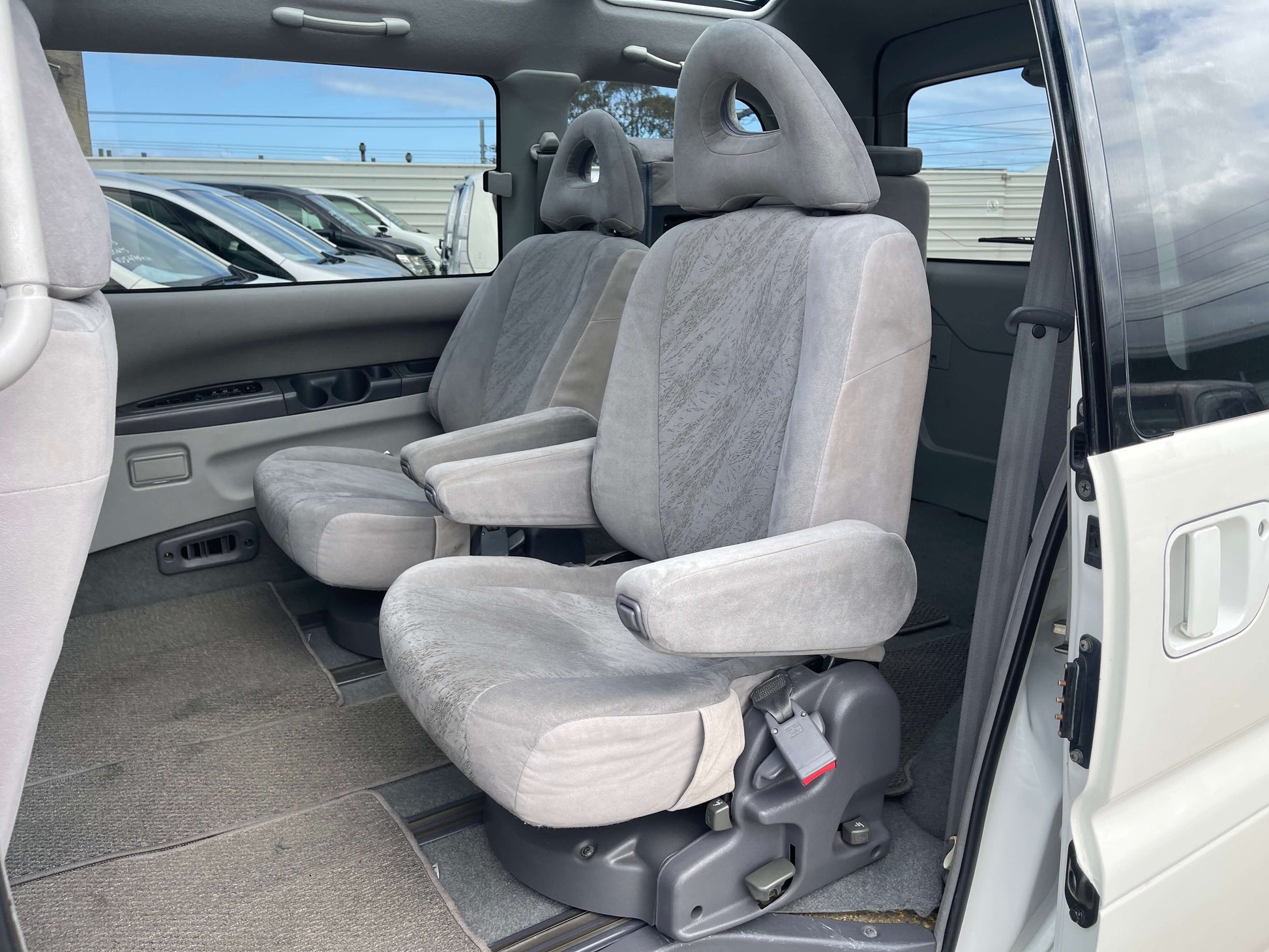Interior of 2006 Mitsubishi Delica showing comfortable grey fabric seats in the front row.