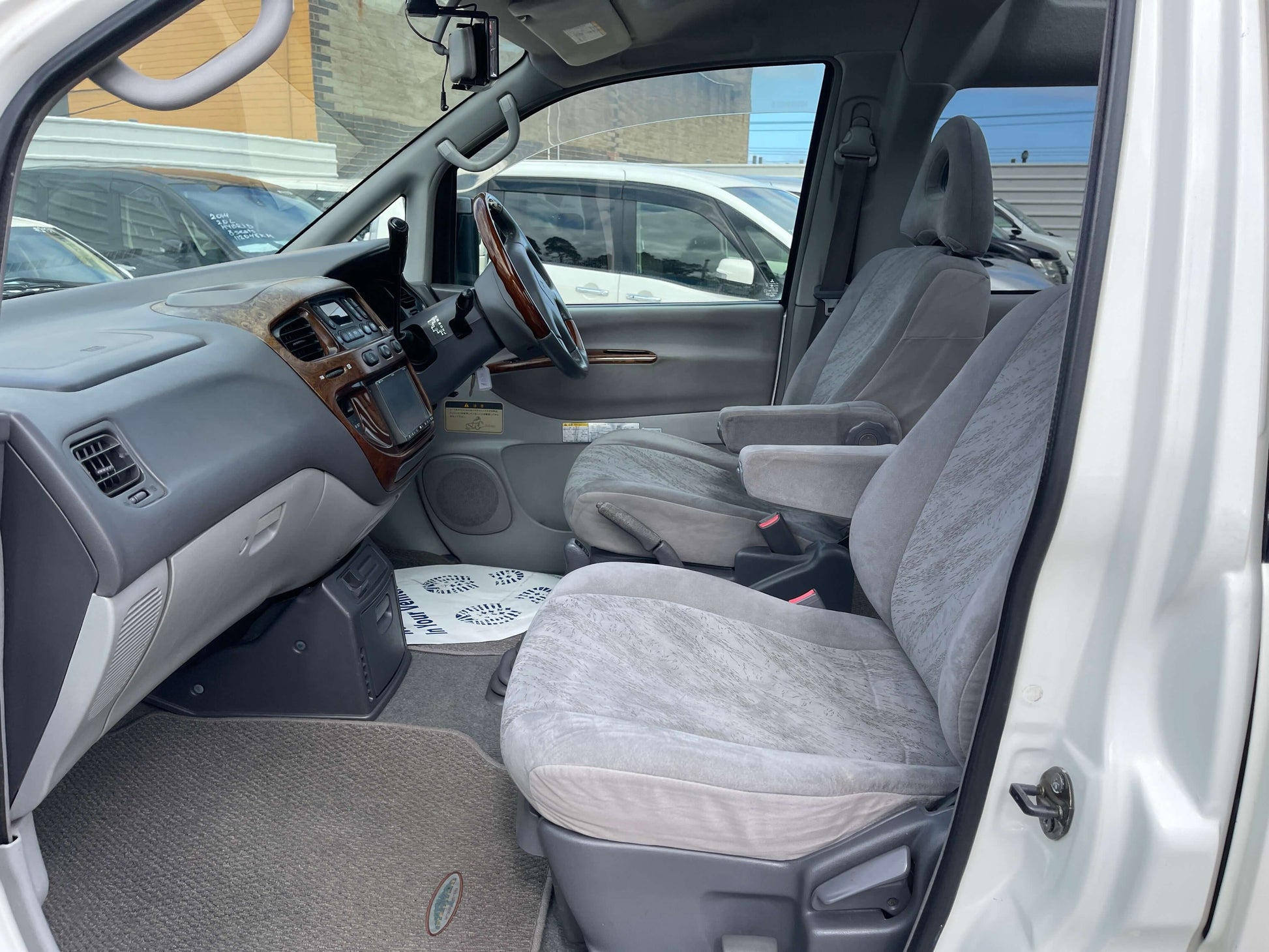 Interior view of 2006 Mitsubishi Delica V6 3.0L 4WD Active Field edition with spacious grey seats.