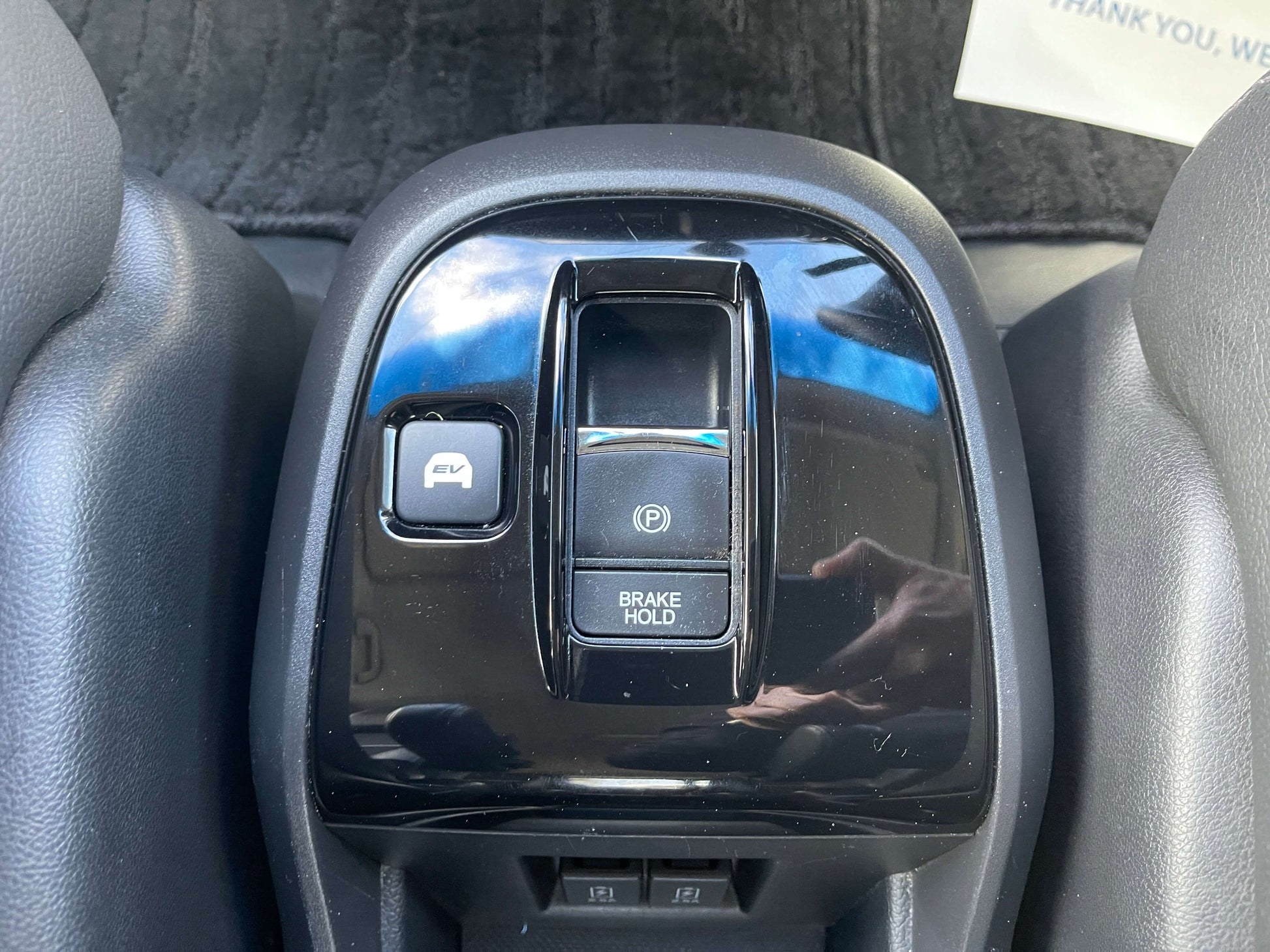Interior control panel of the 2018 Honda Stepwgn 2.0 Spada Hybrid G featuring brake hold and parking brake buttons.