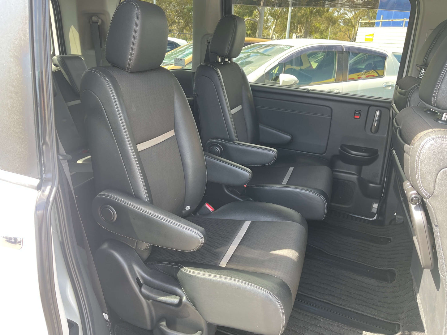 2018 Honda Stepwgn 2.0 Spada Hybrid G Honda Sensing interior view of front seats with black upholstery.