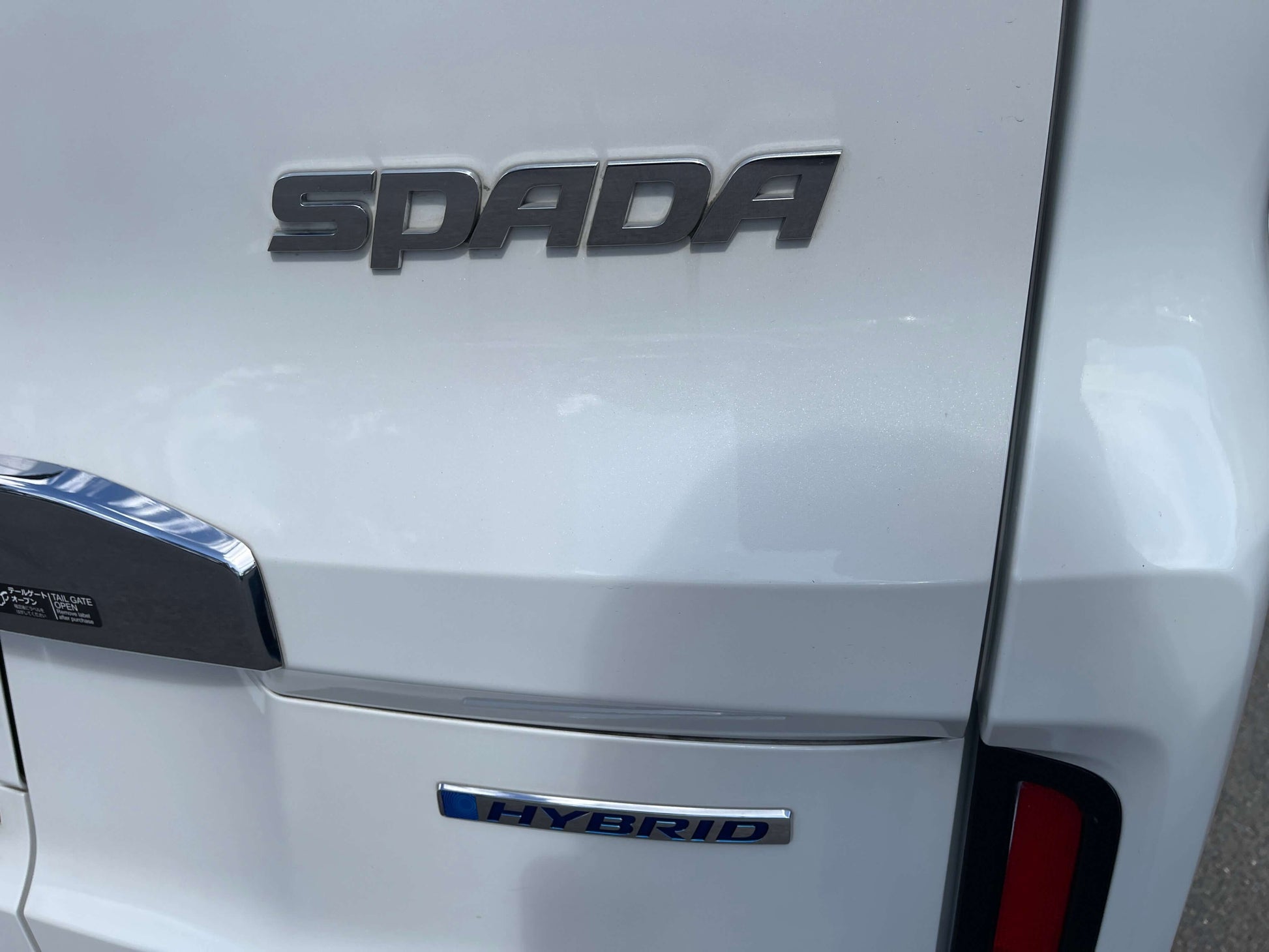 Close-up of 2018 Honda Stepwgn 2.0 Spada Hybrid rear badge showcasing 'SPADA' and 'HYBRID' emblems.