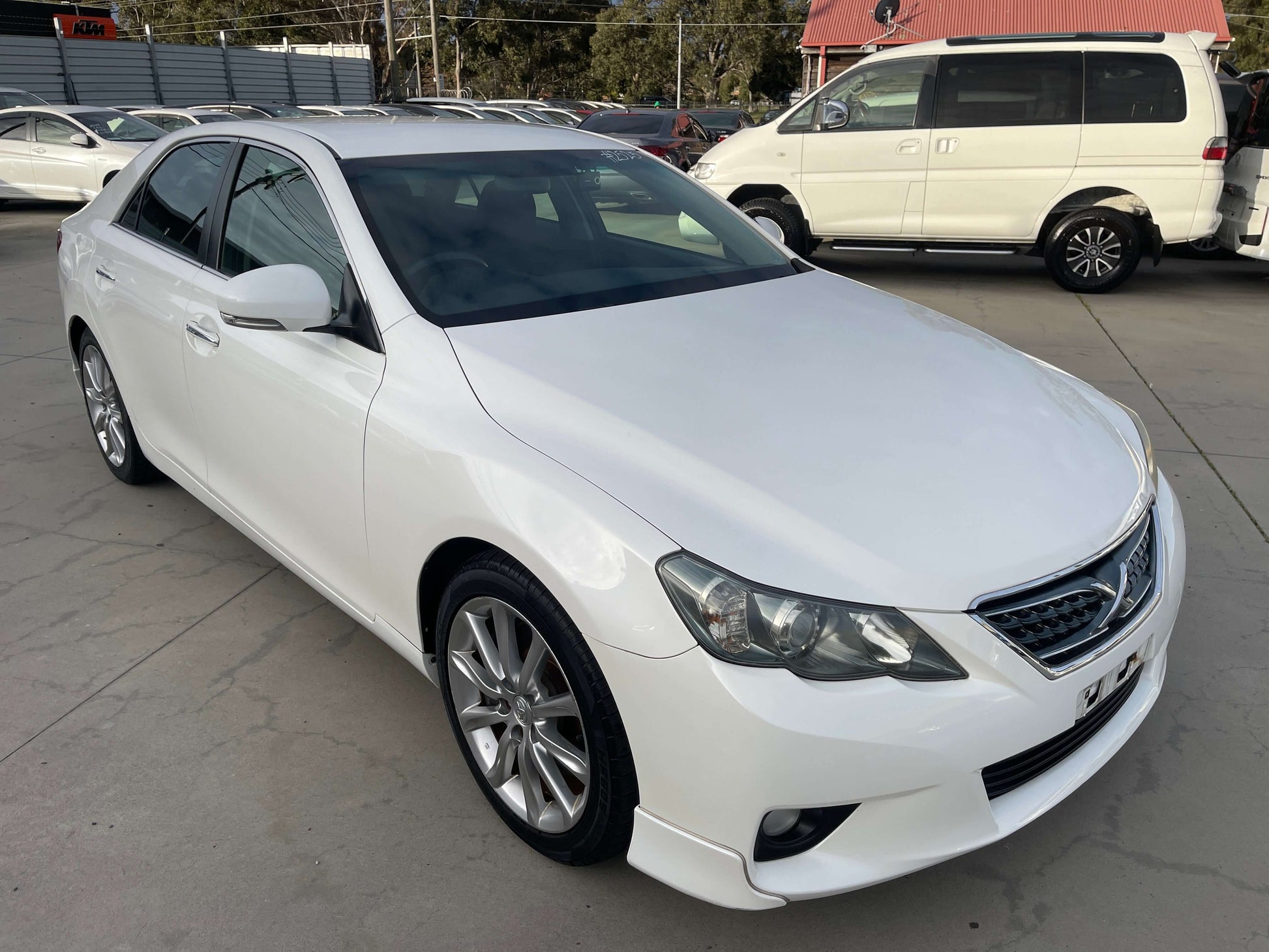 2011 Toyota Mark X V6 3.5L 350S Sport Sedan in white exterior, showcasing sleek design and sporty elements.
