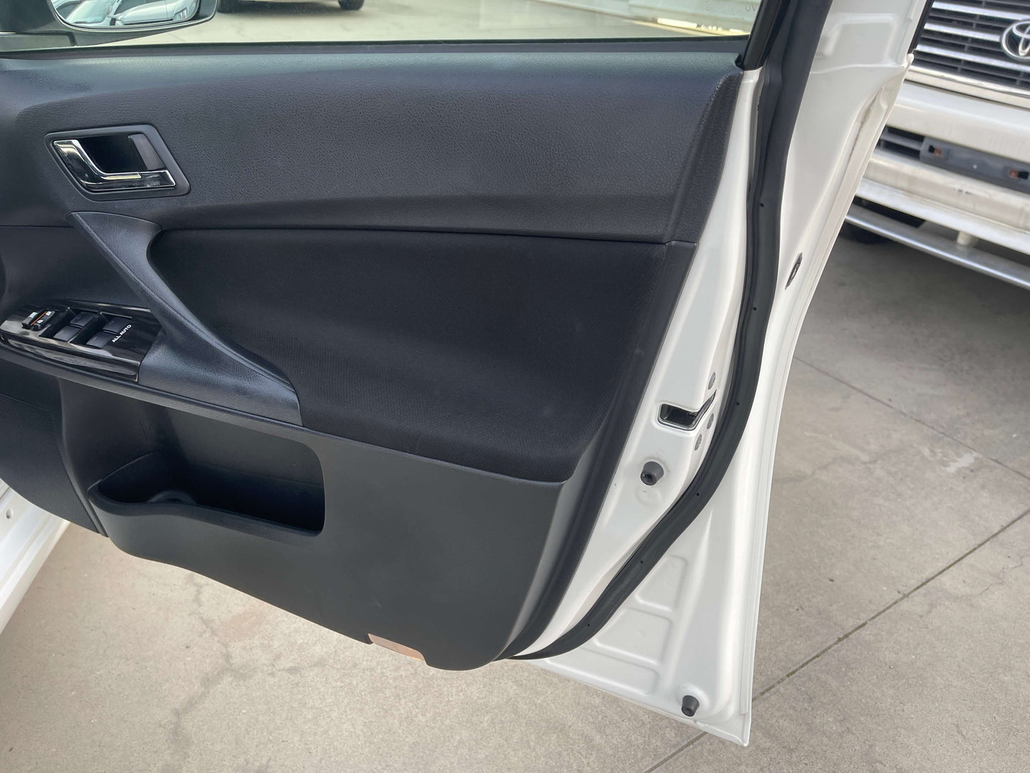 Interior door panel of a 2011 Toyota Mark X V6 3.5L 350S Sport Sedan showcasing modern design and features.